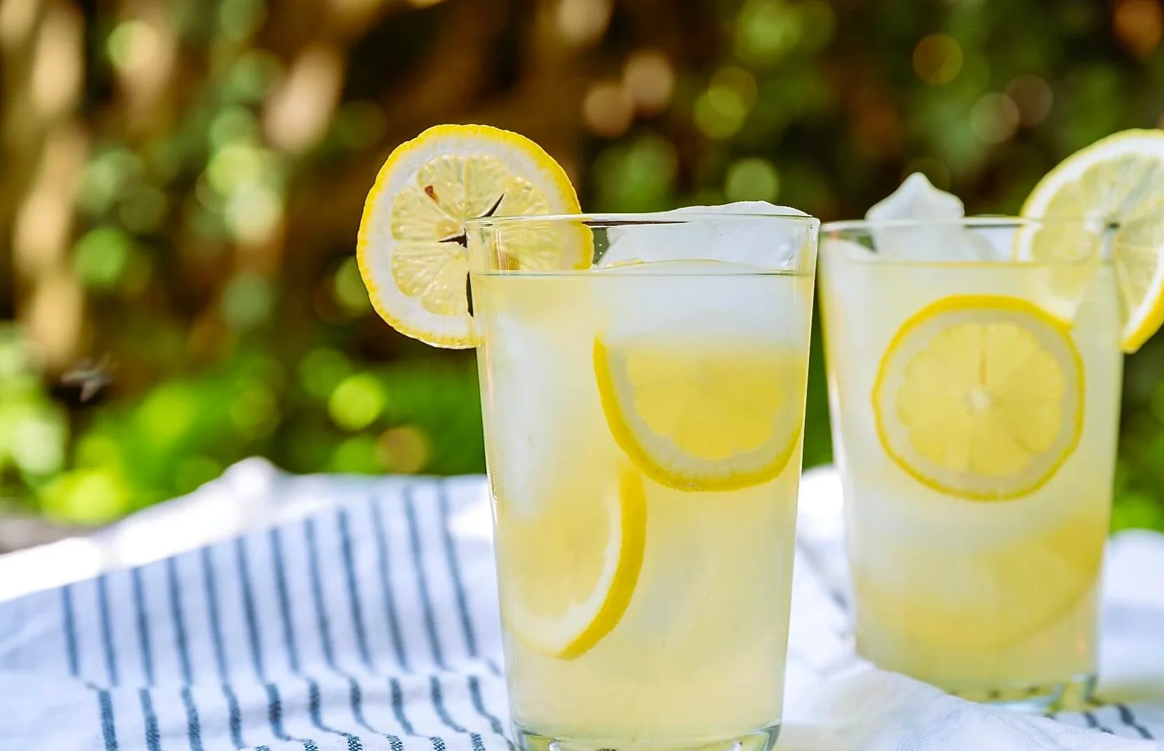 Refreshing lemonade served in tall glasses with lemon slices