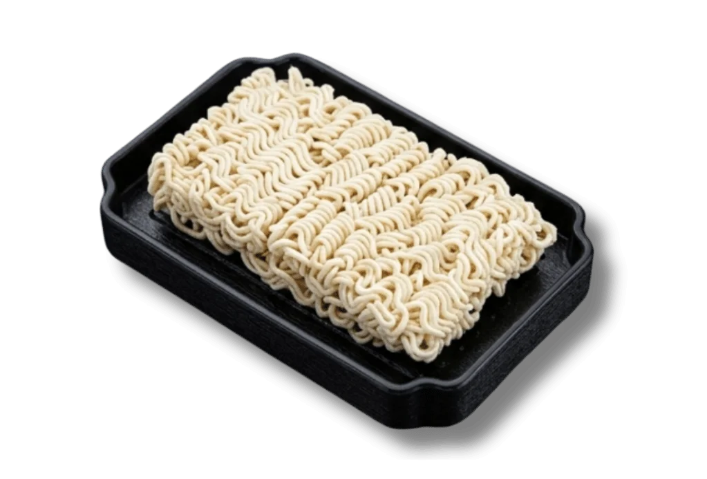 Packaged instant ramen noodles on a black tray.