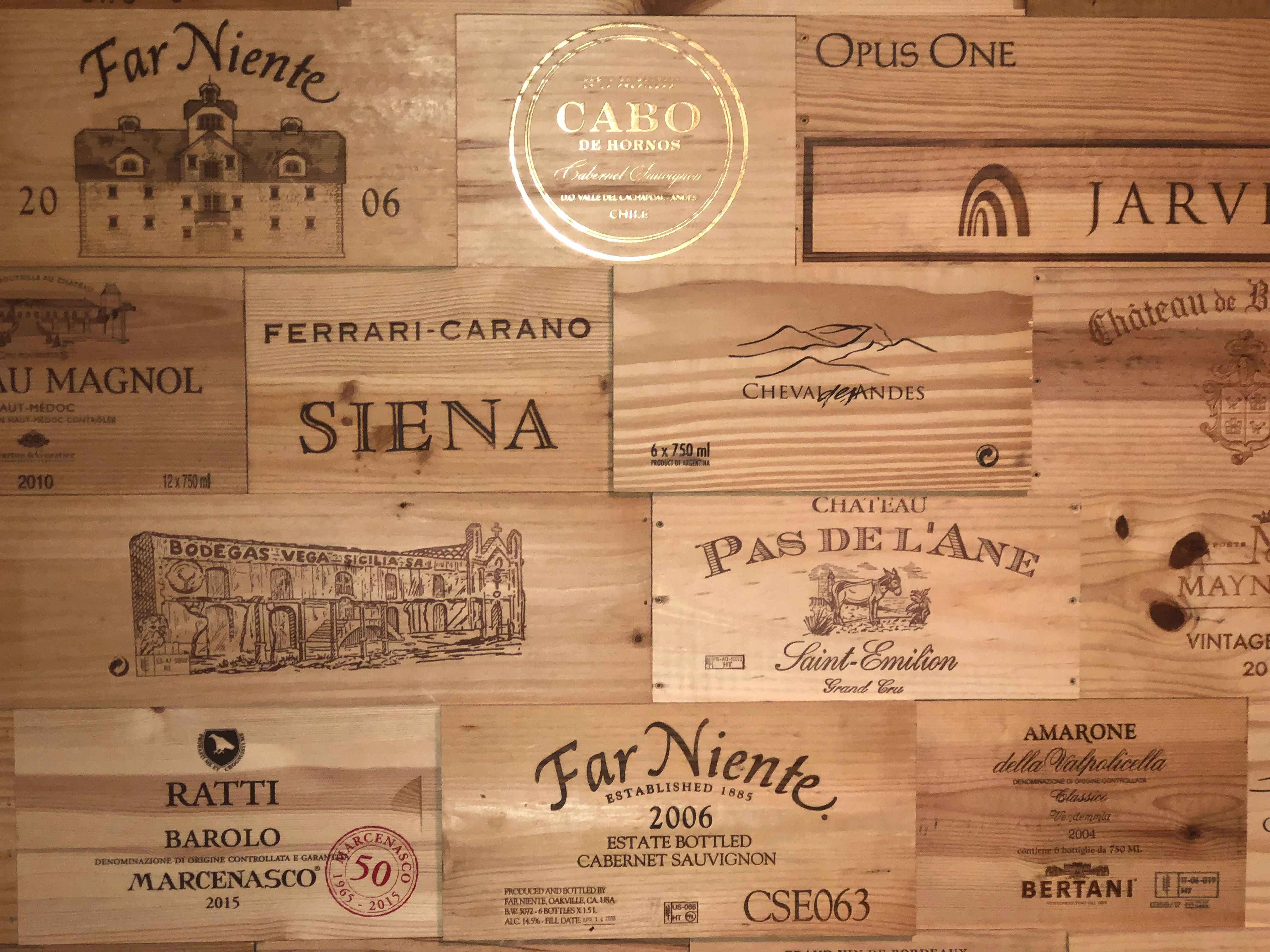 Wooden wine box labels showcasing various vineyards and brands