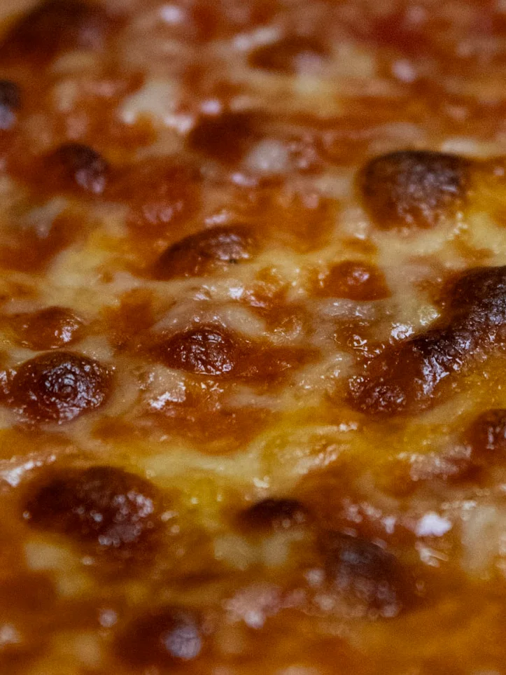 Sicilian-style pizza topped with marinara and fresh basil