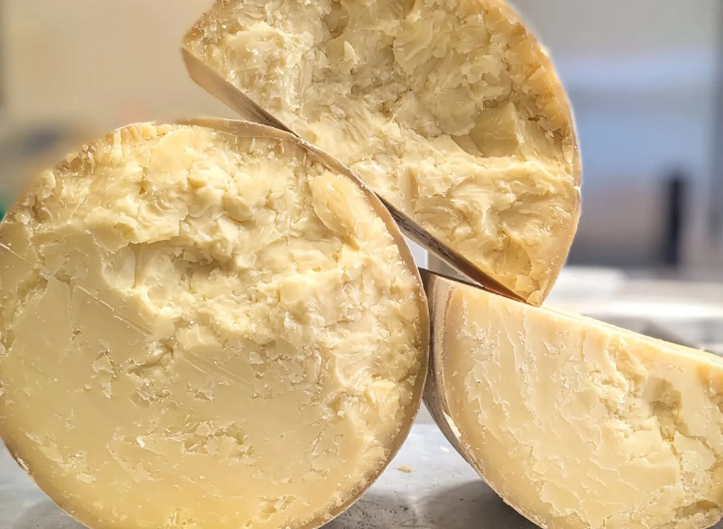 Aged cheese wheels showcasing rich texture