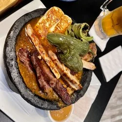 Sizzling Mexican fajitas served in a stone bowl