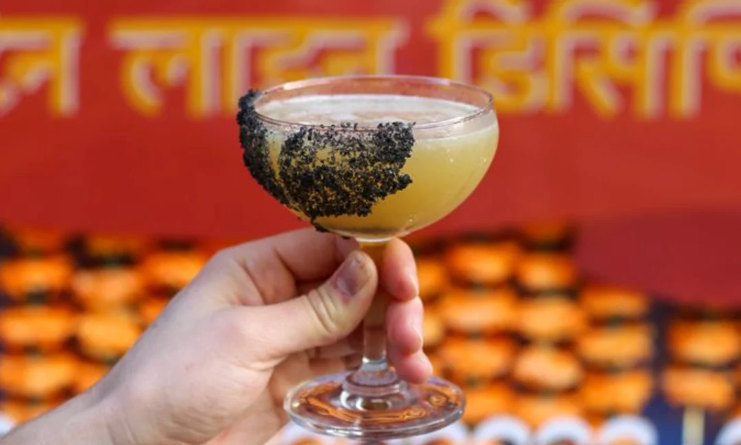 Craft cocktail with black salt rim in a stylish glass