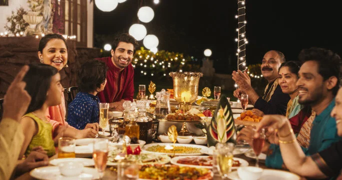 Family gathering with traditional Indian feast under festive lights
