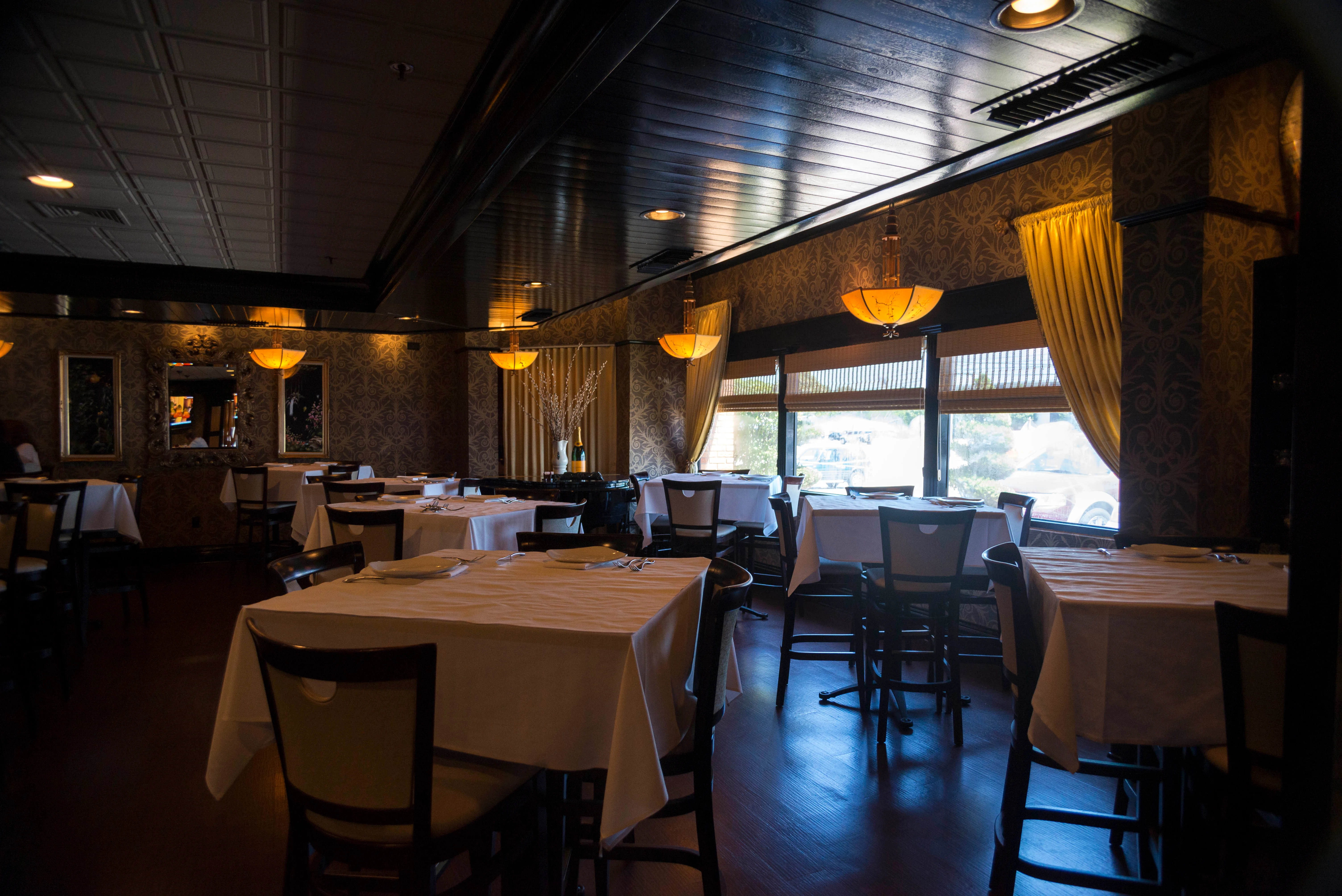 Elegant restaurant interior with warm lighting and table settings