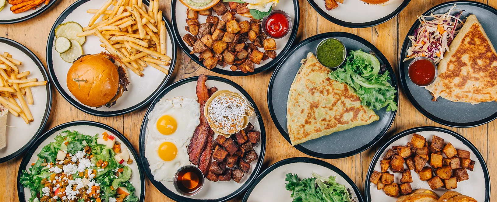 Variety of American brunch dishes including burgers and breakfast plates