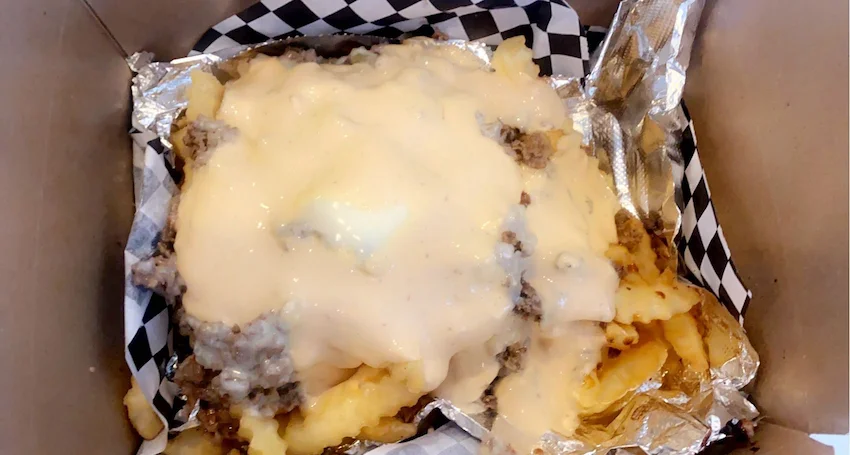 Loaded cheese fries with ground beef and creamy sauce