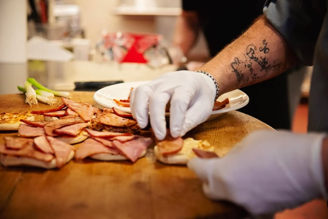 Chef preparing Italian focaccia with ham slices