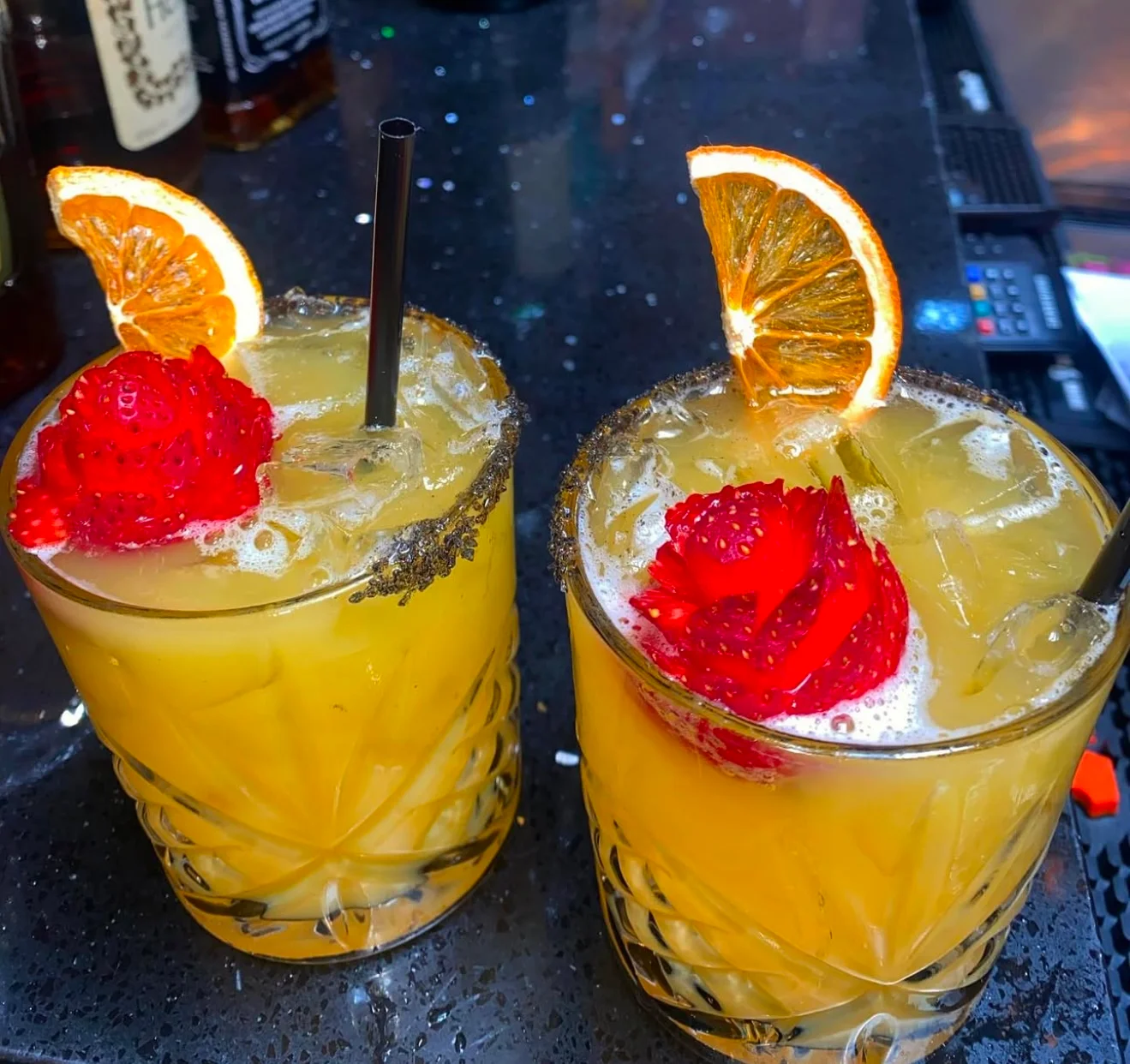 Colorful cocktails garnished with fruit at a stylish bar