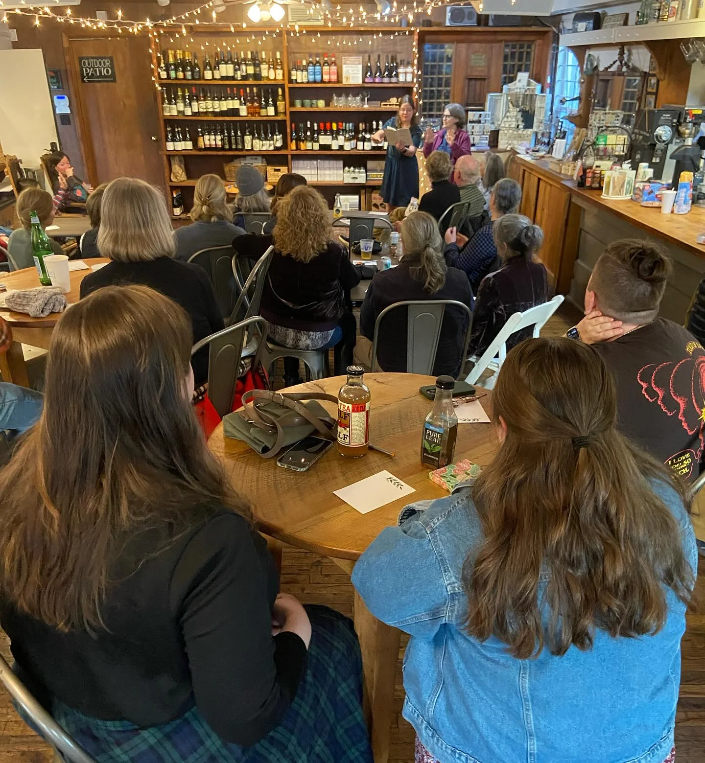 Cozy restaurant event with guests seated and speakers at the front