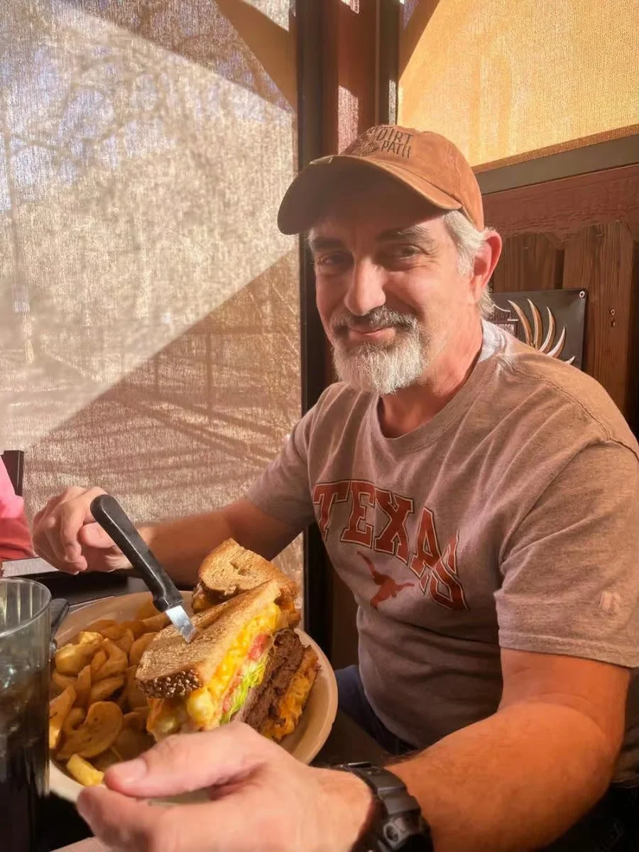 Hearty Texas-style burger with fries in a cozy restaurant setting