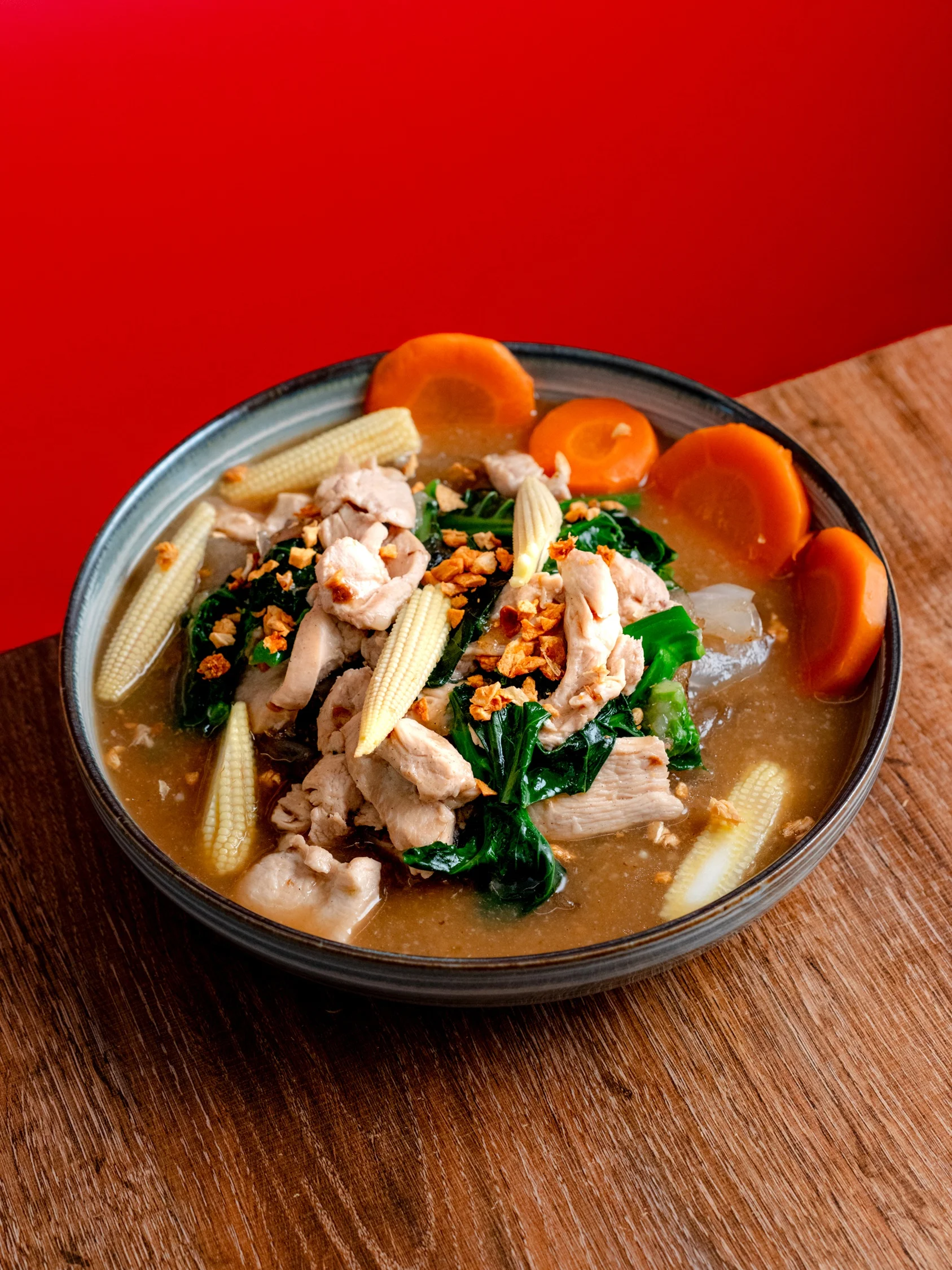Bowl of Thai chicken soup with vegetables