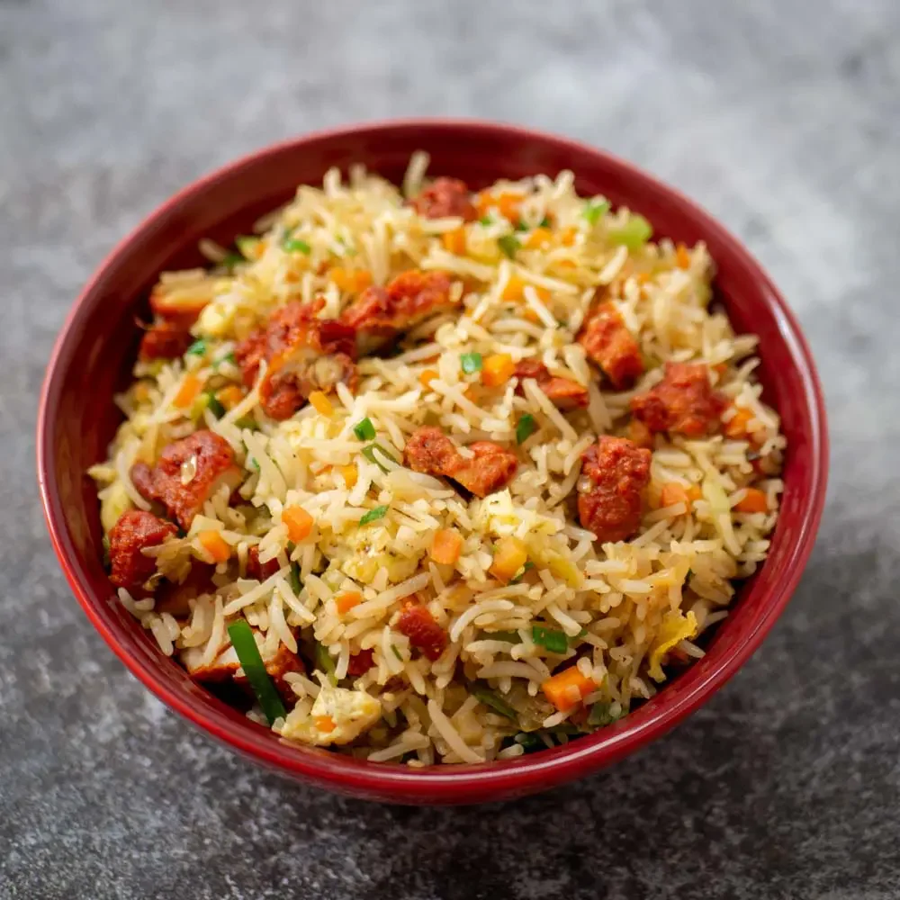 Flavorful Indian biryani served in a red bowl