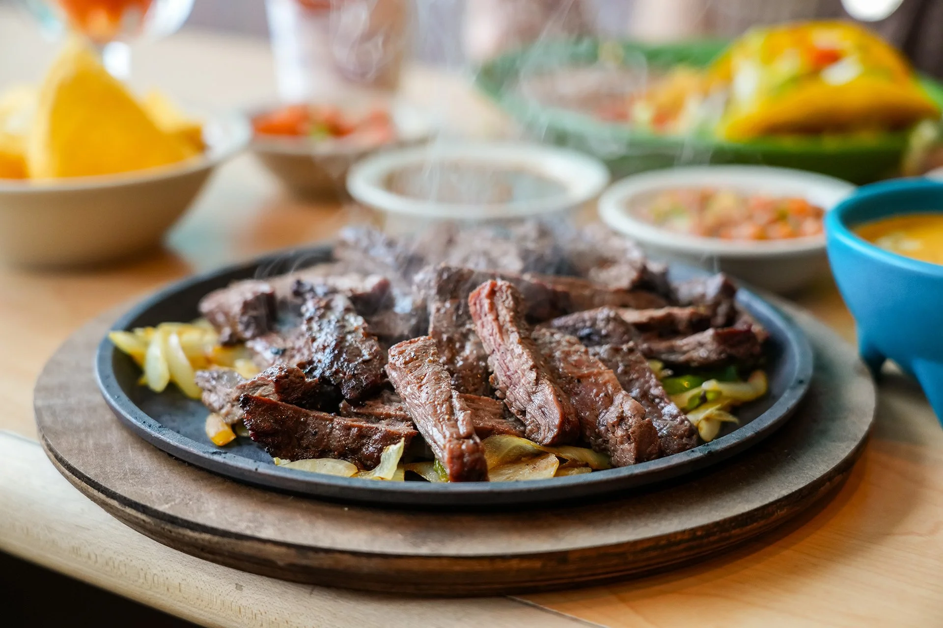 Sizzling fajitas served on a hot skillet