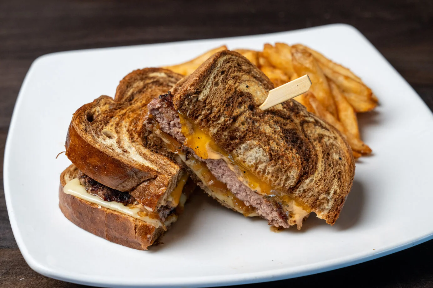 Grilled cheese burger sandwich with fries
