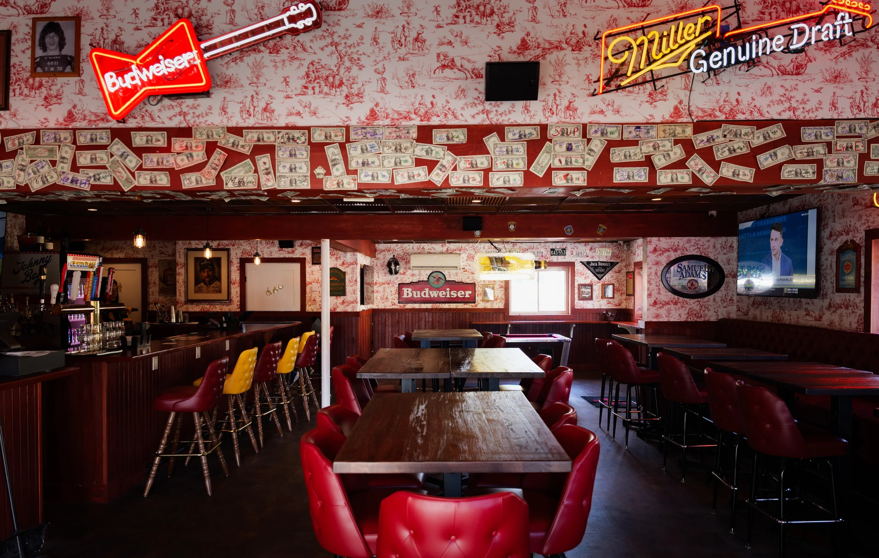 Cozy bar interior with neon signs and wooden tables