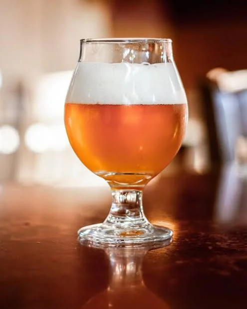 Craft beer in a tulip glass with frothy head