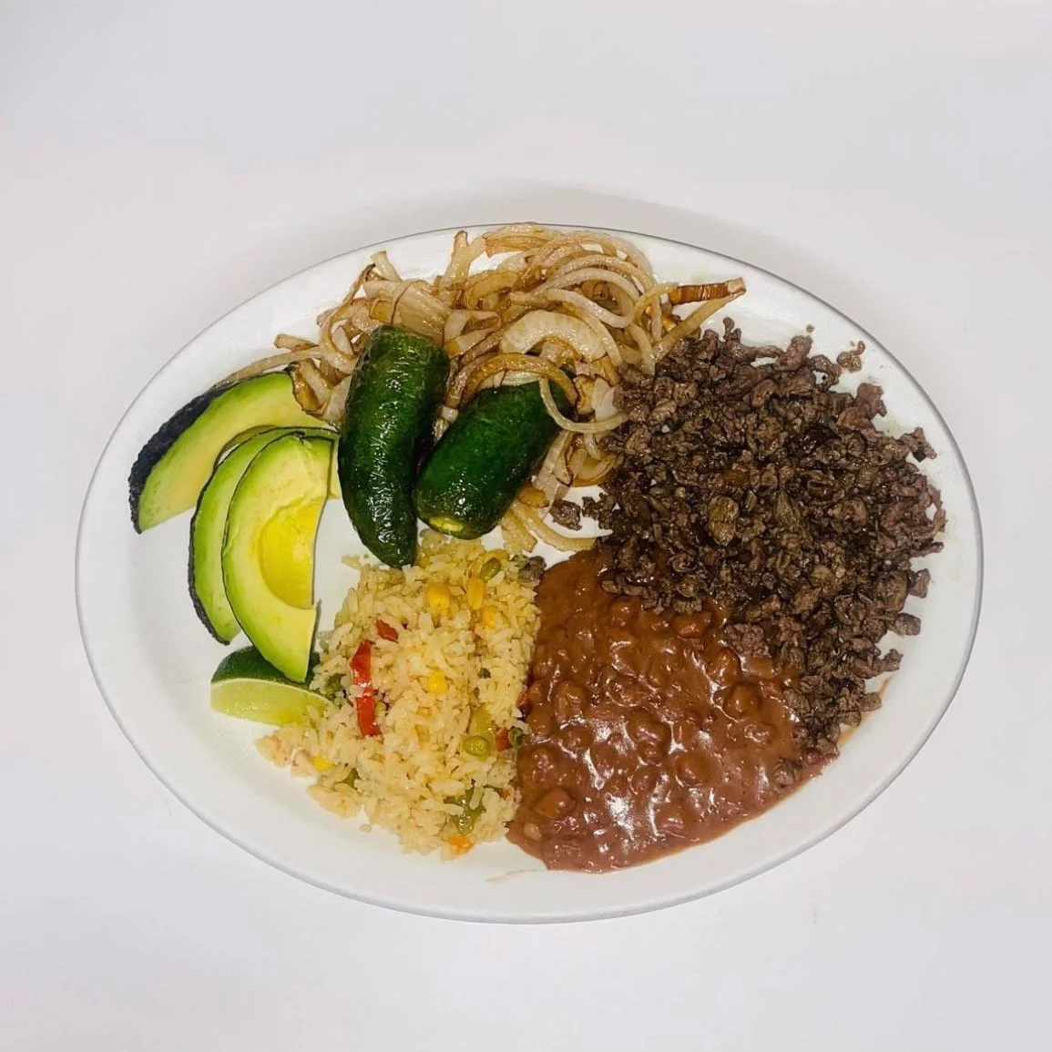 Traditional Mexican plate with carne asada, rice, and beans