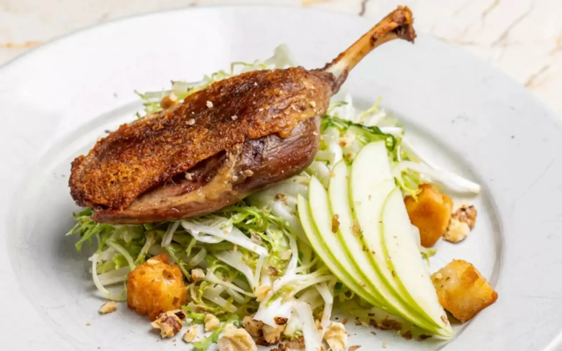 Crispy duck confit served on a fresh salad