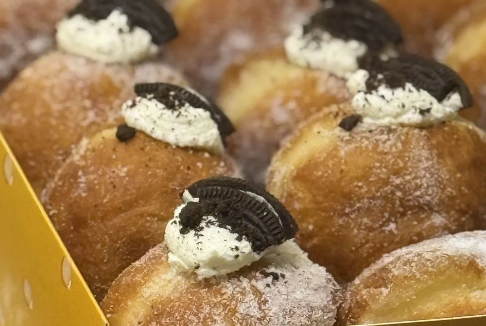 Delicious Oreo cream-filled doughnuts in a vibrant box