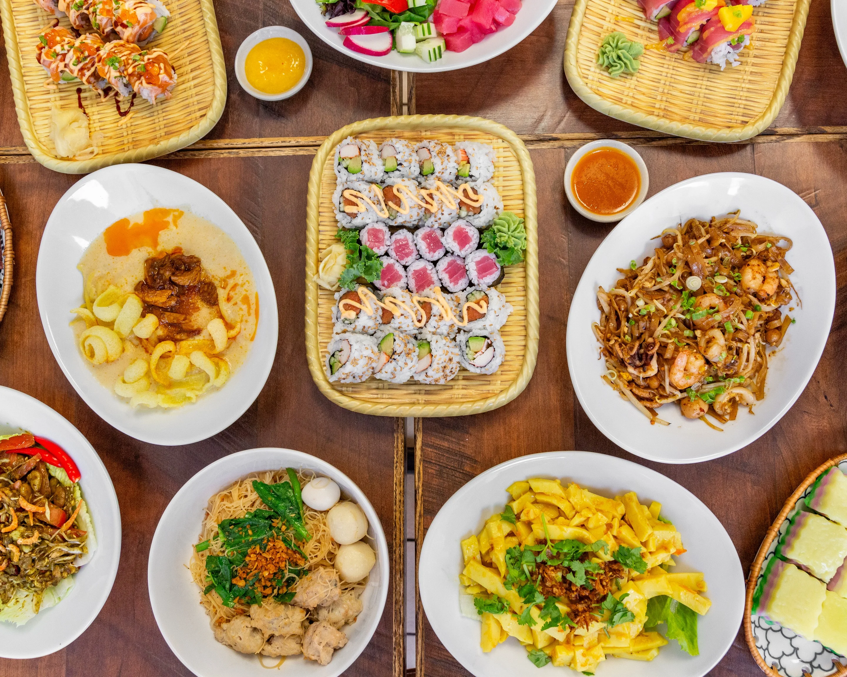 Assorted Asian dishes including sushi and pad thai