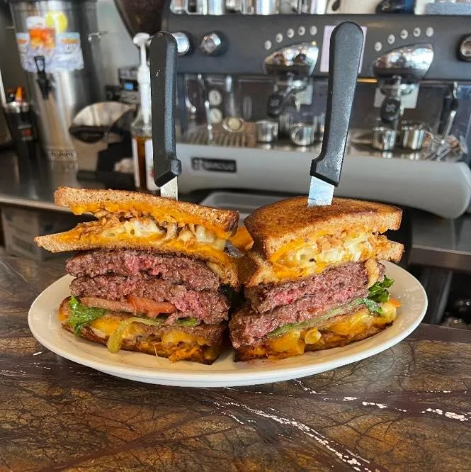 Holy Moly Burger - Two half pound patties with bacon, French fried onions, melted cheddar cheese, lettuce, tomato, onion and pickles, all sandwiched between two mac n’ cheese grilled cheese sandwiches. Includes French Fries.
