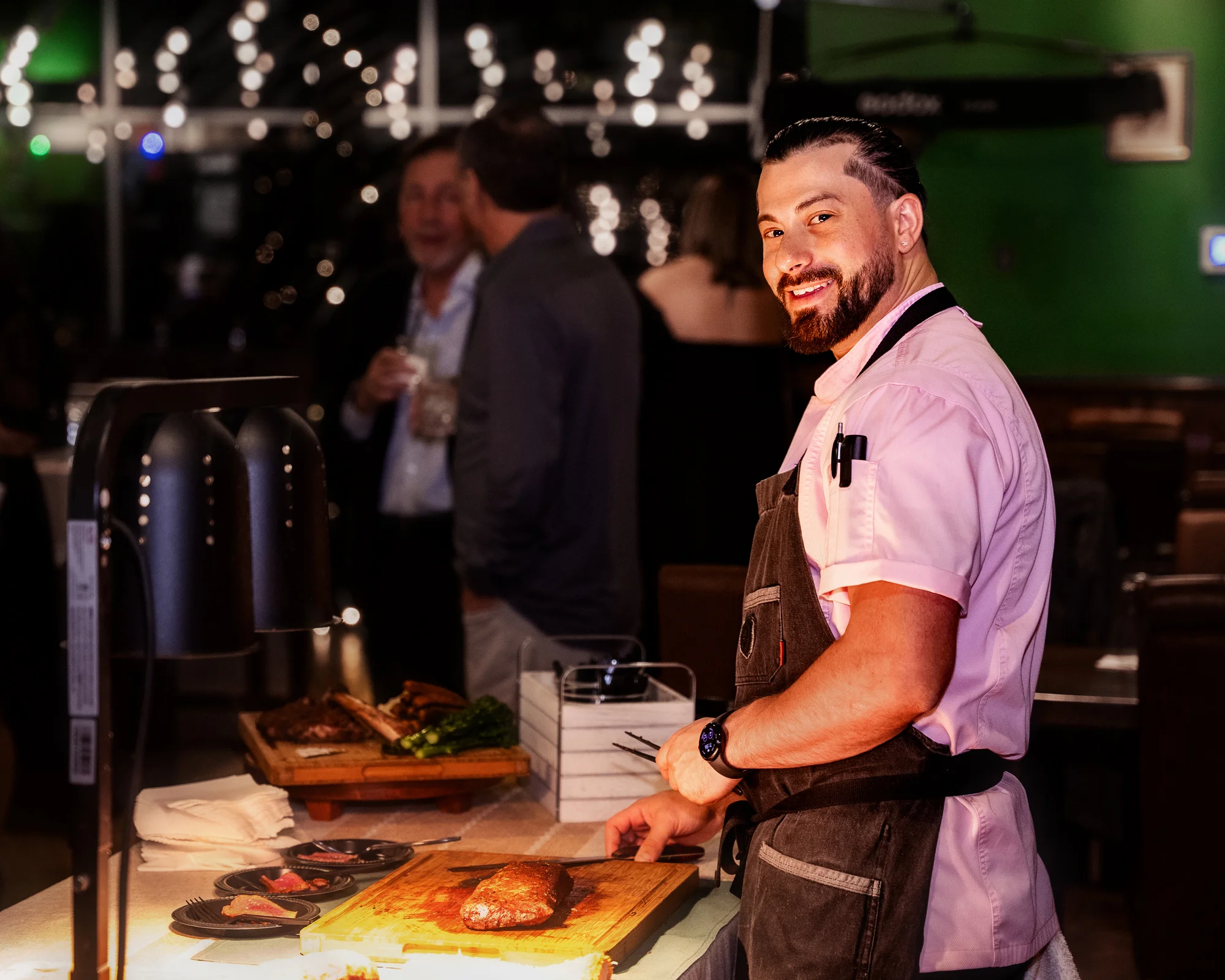 Chef Dante at a carving station serving delicious meats.