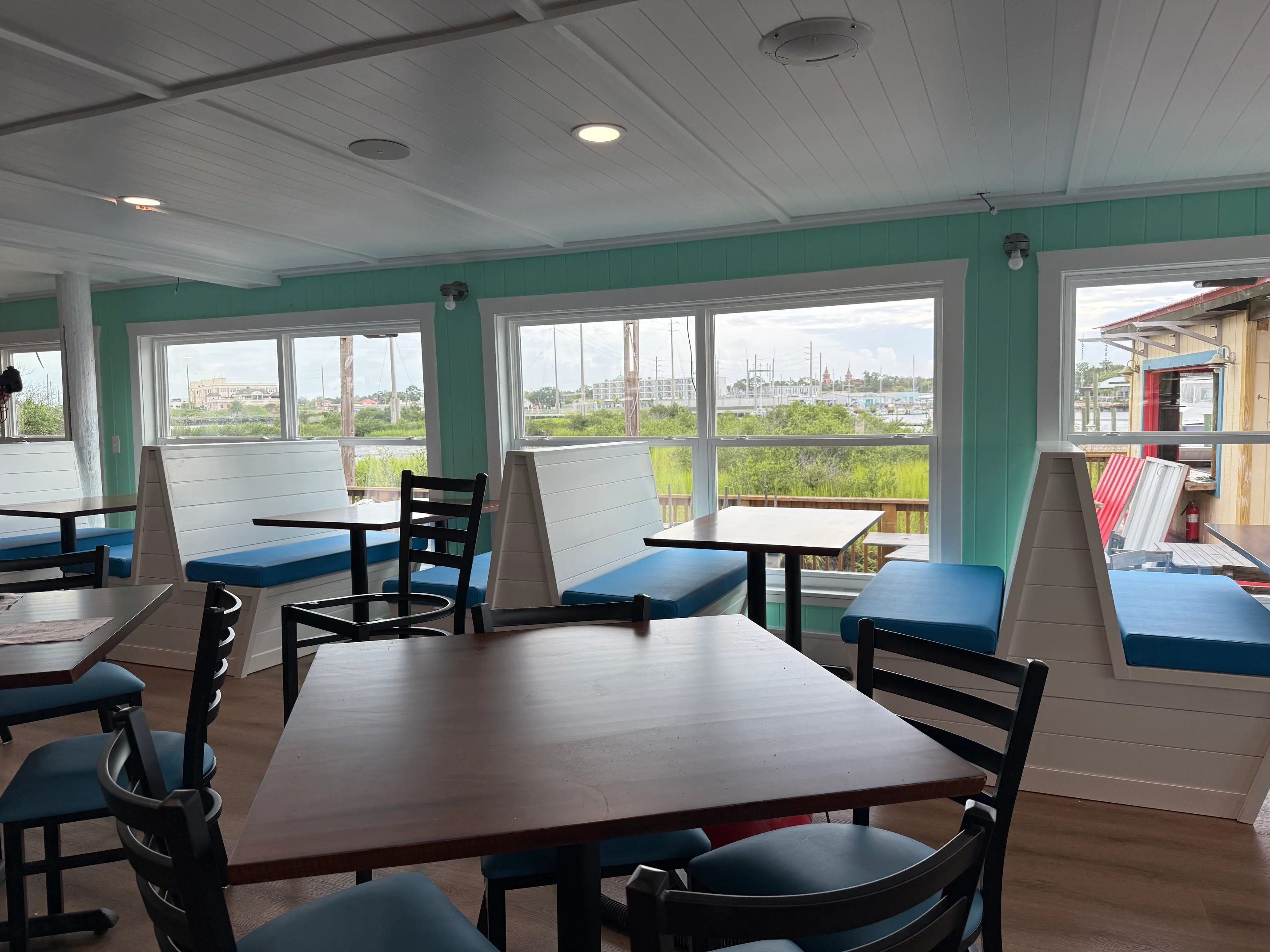 Bright restaurant interior with waterfront views and cozy seating