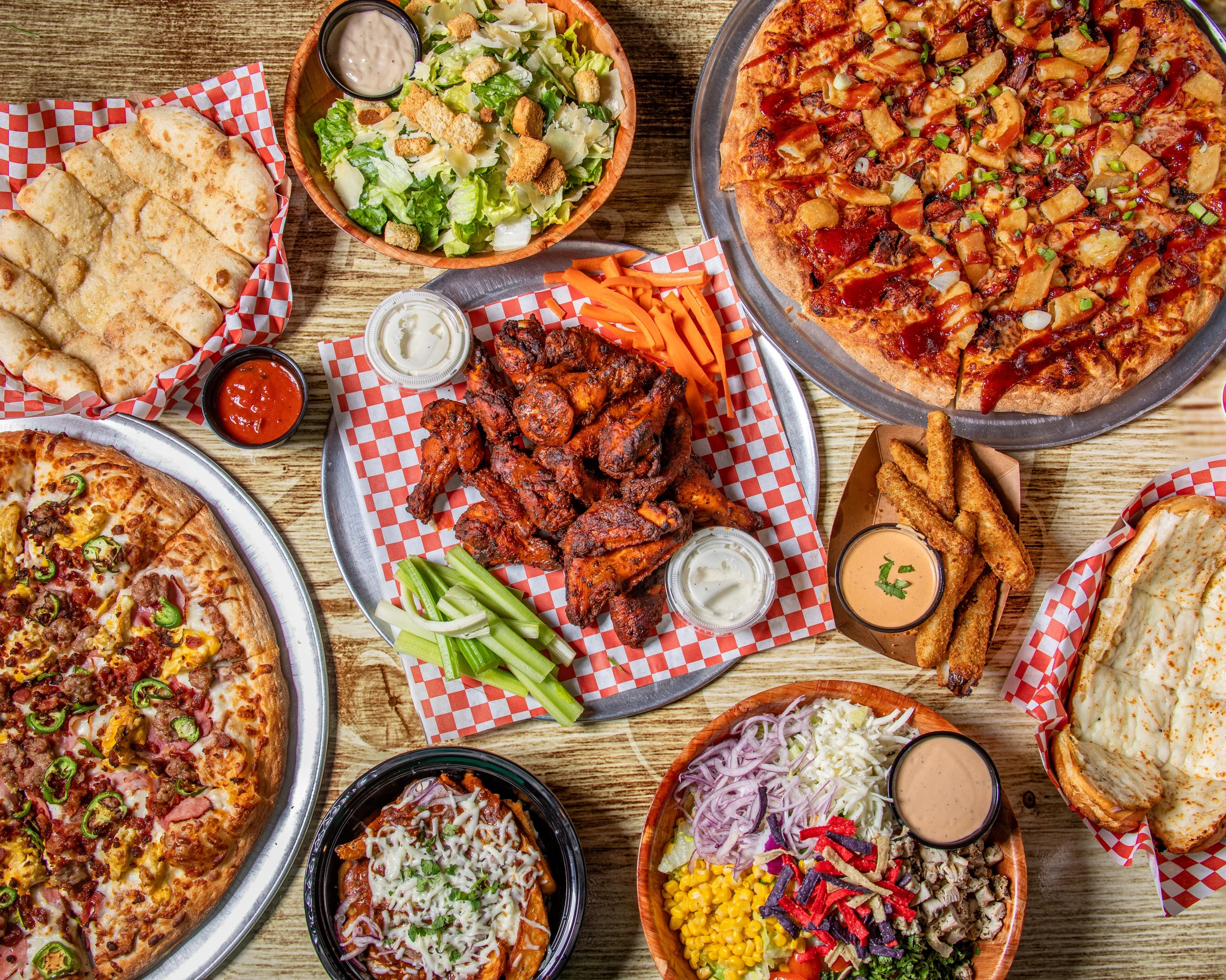 Assorted American comfort food platter with pizza and wings