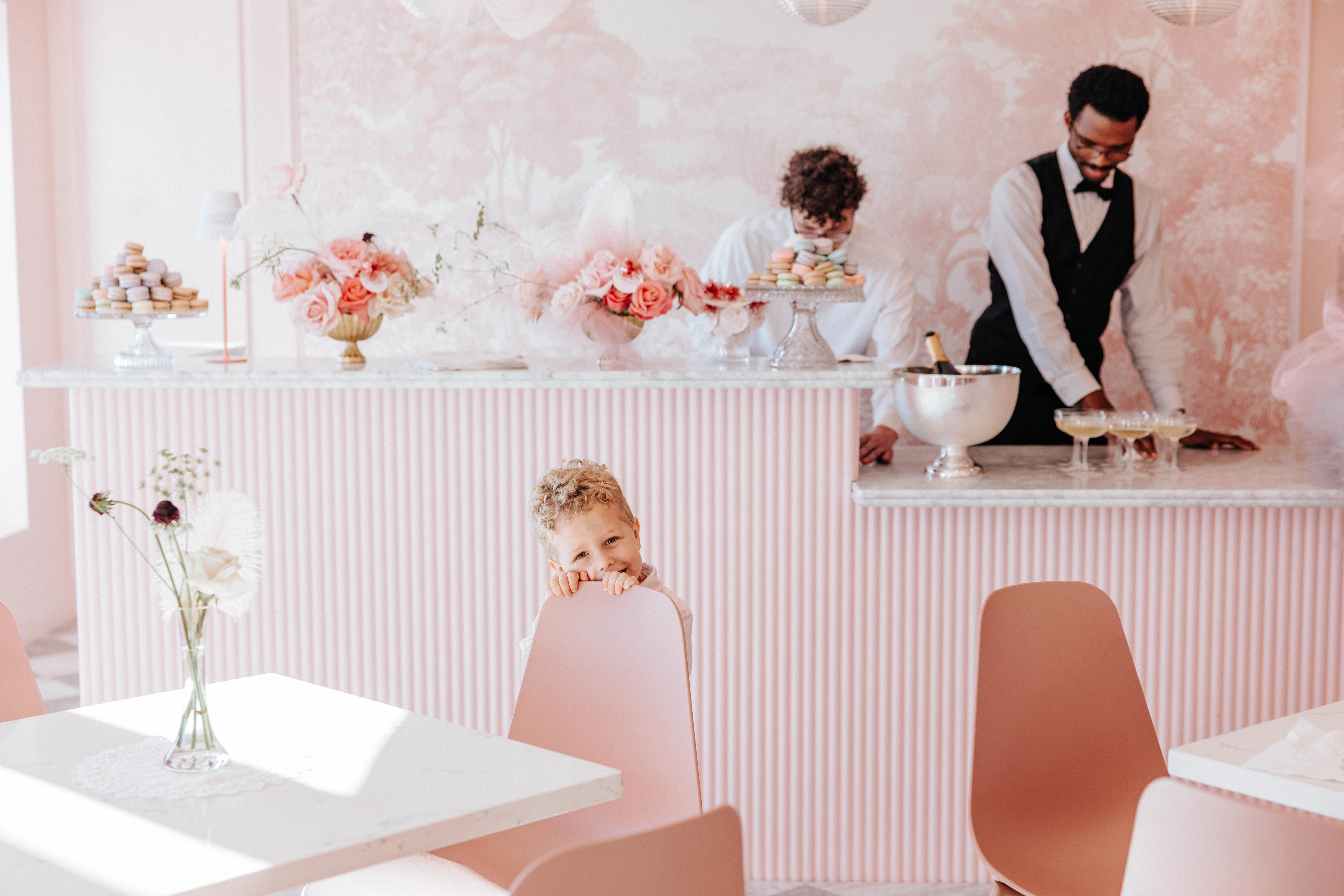 Charming café interior with pink decor and desserts