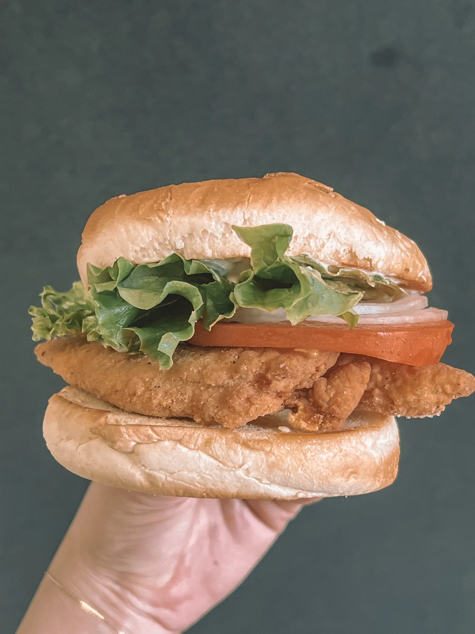 Crispy fried chicken sandwich with lettuce and tomato