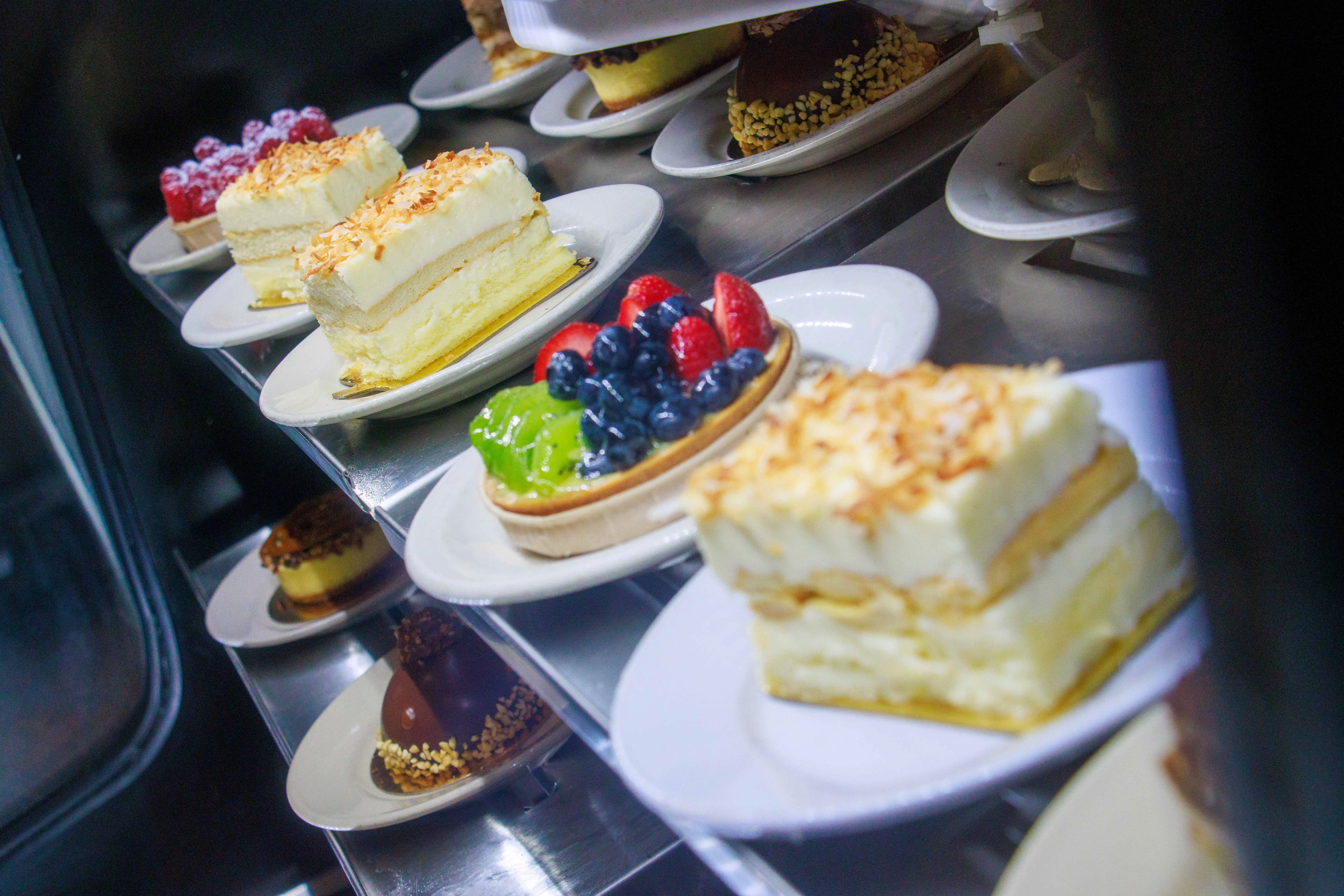 Assorted desserts including coconut cake and fruit tart