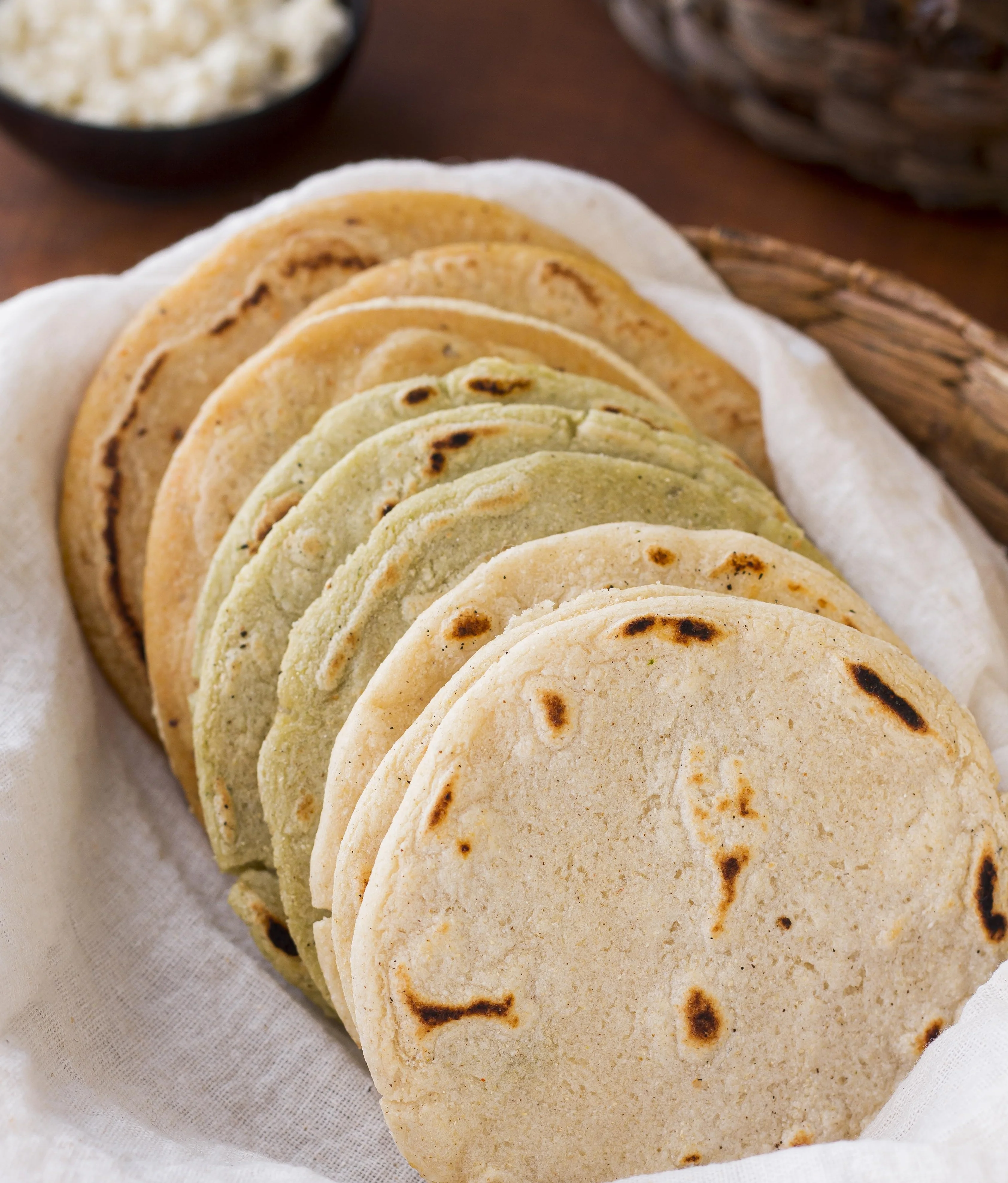 Delicious tortillas served with fresh ingredients on a wooden table.