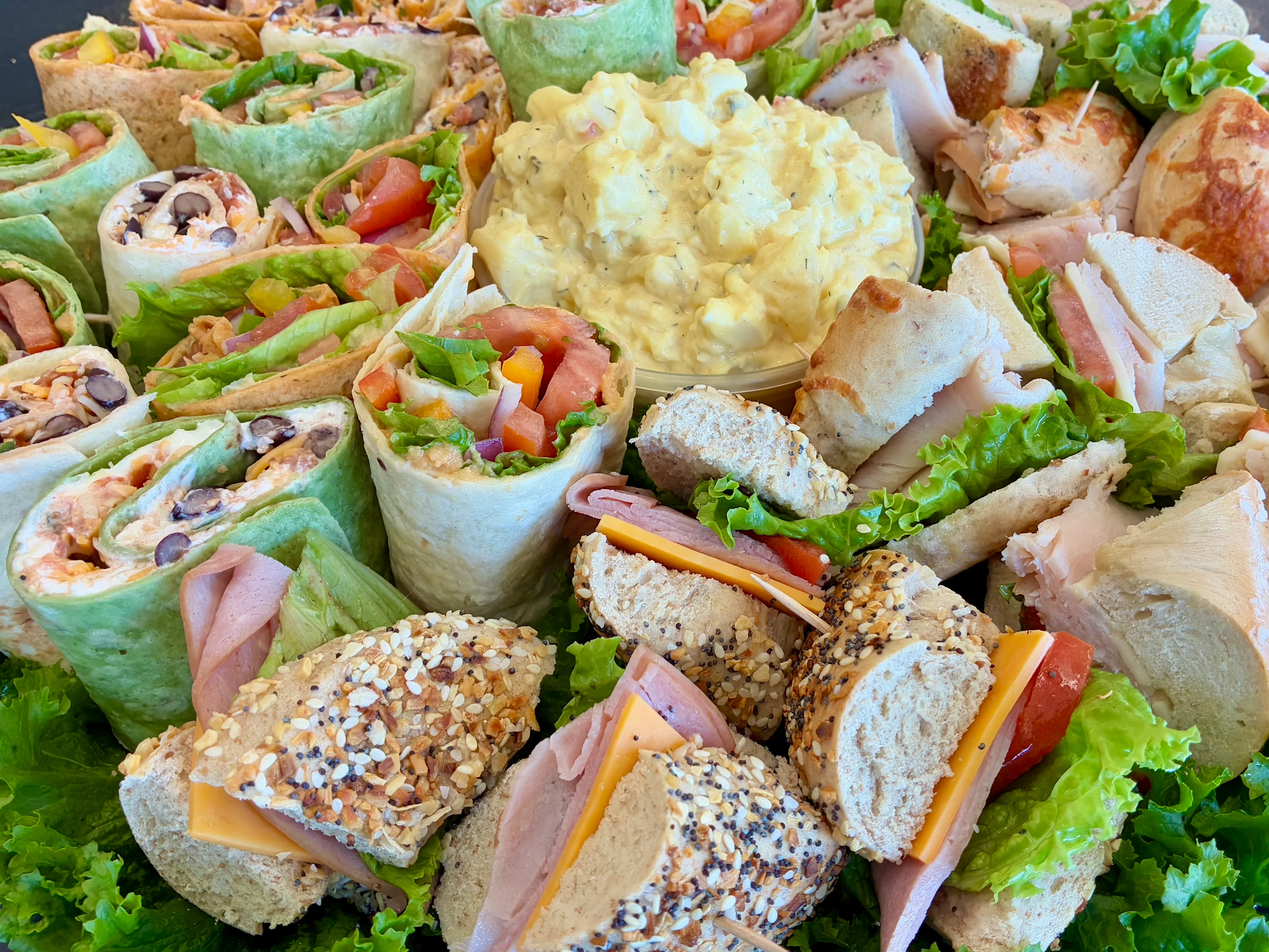 A beautifully arranged catering display with various dishes and garnishes.