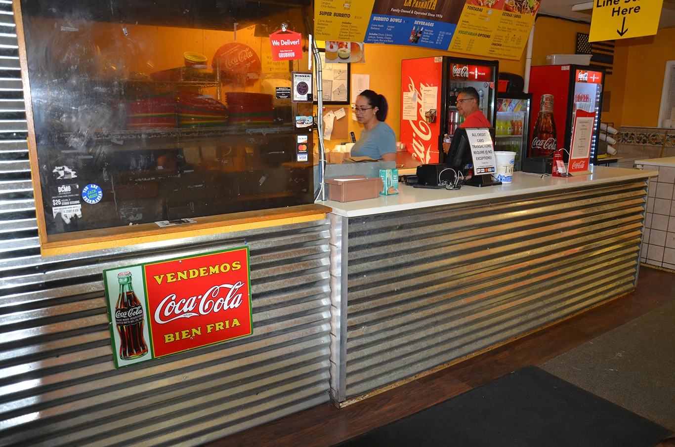 Cozy restaurant counter with vibrant decor and Coca-Cola signage