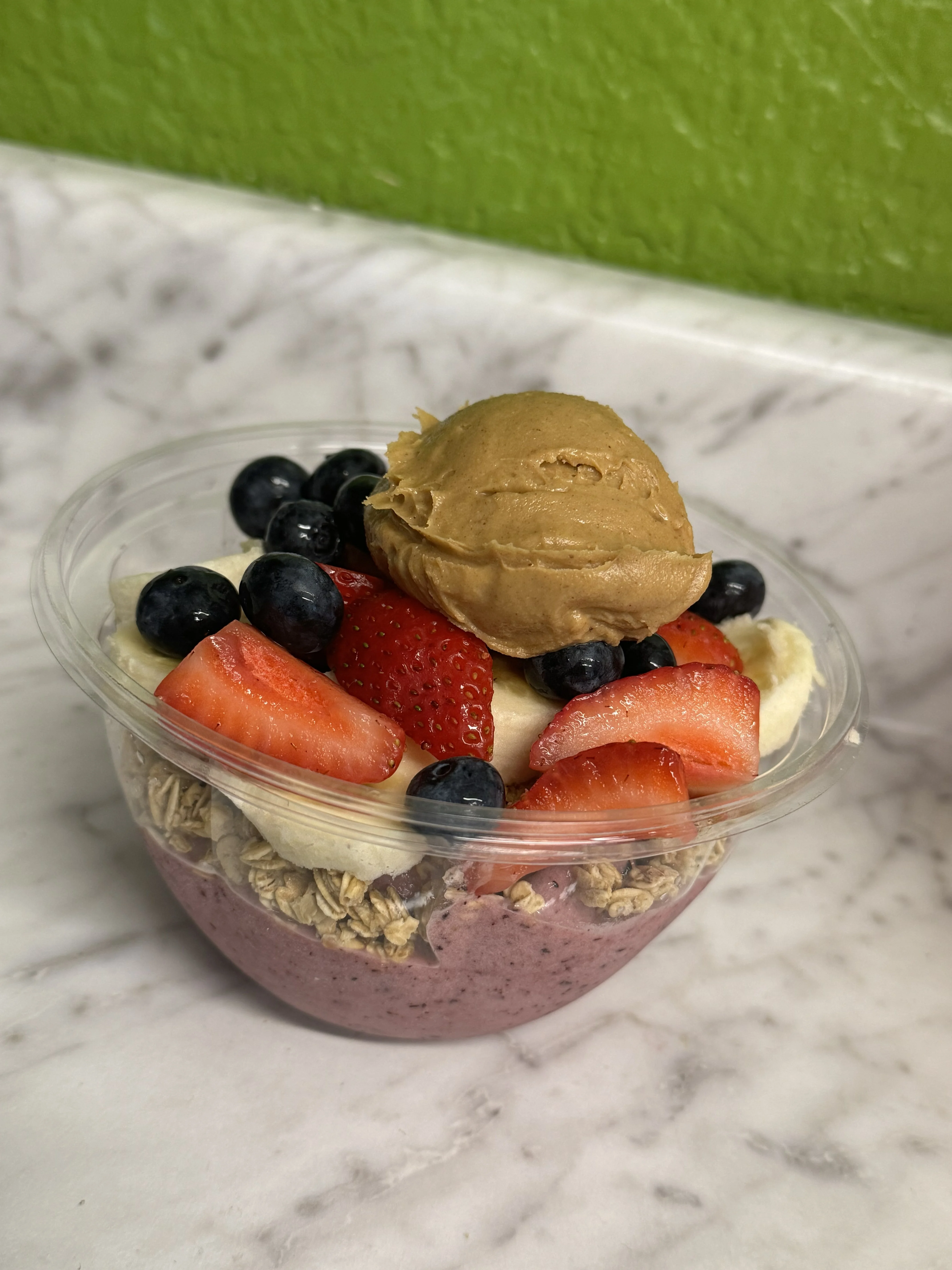 Colorful acai bowl topped with fruits and granola