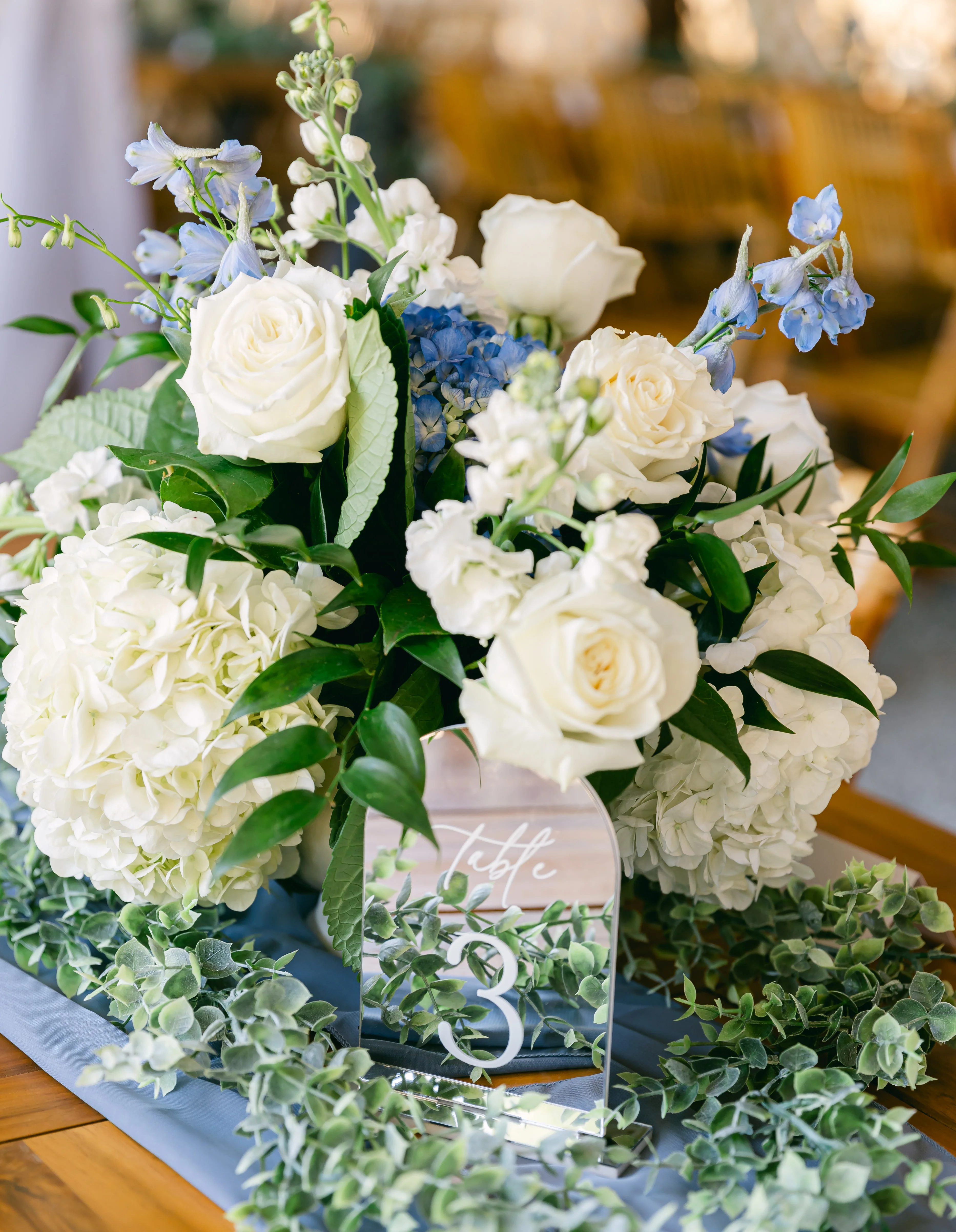 Elegant floral centerpiece with white and blue flowers