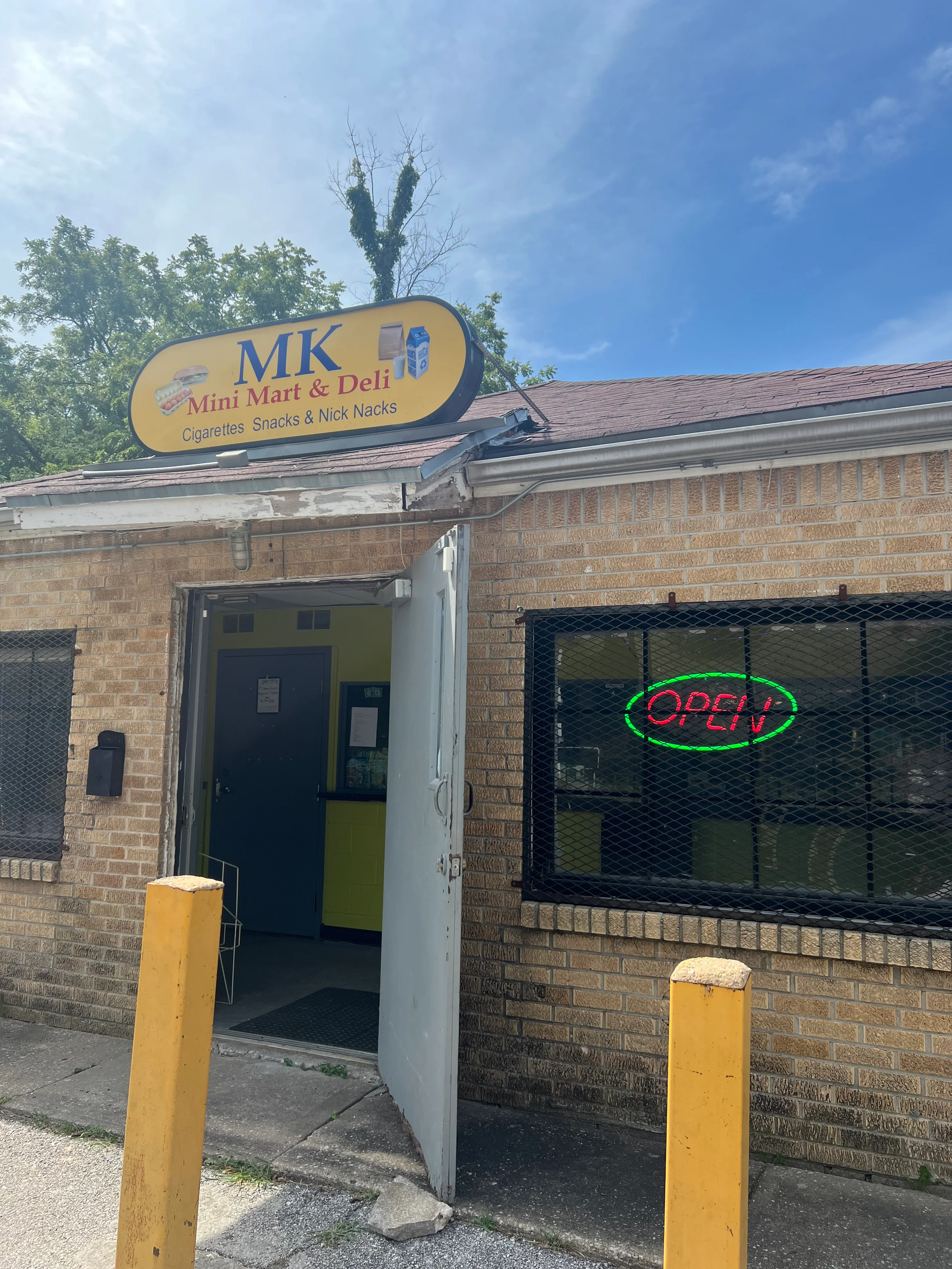 Exterior of MK Mini Mart & Deli with open sign