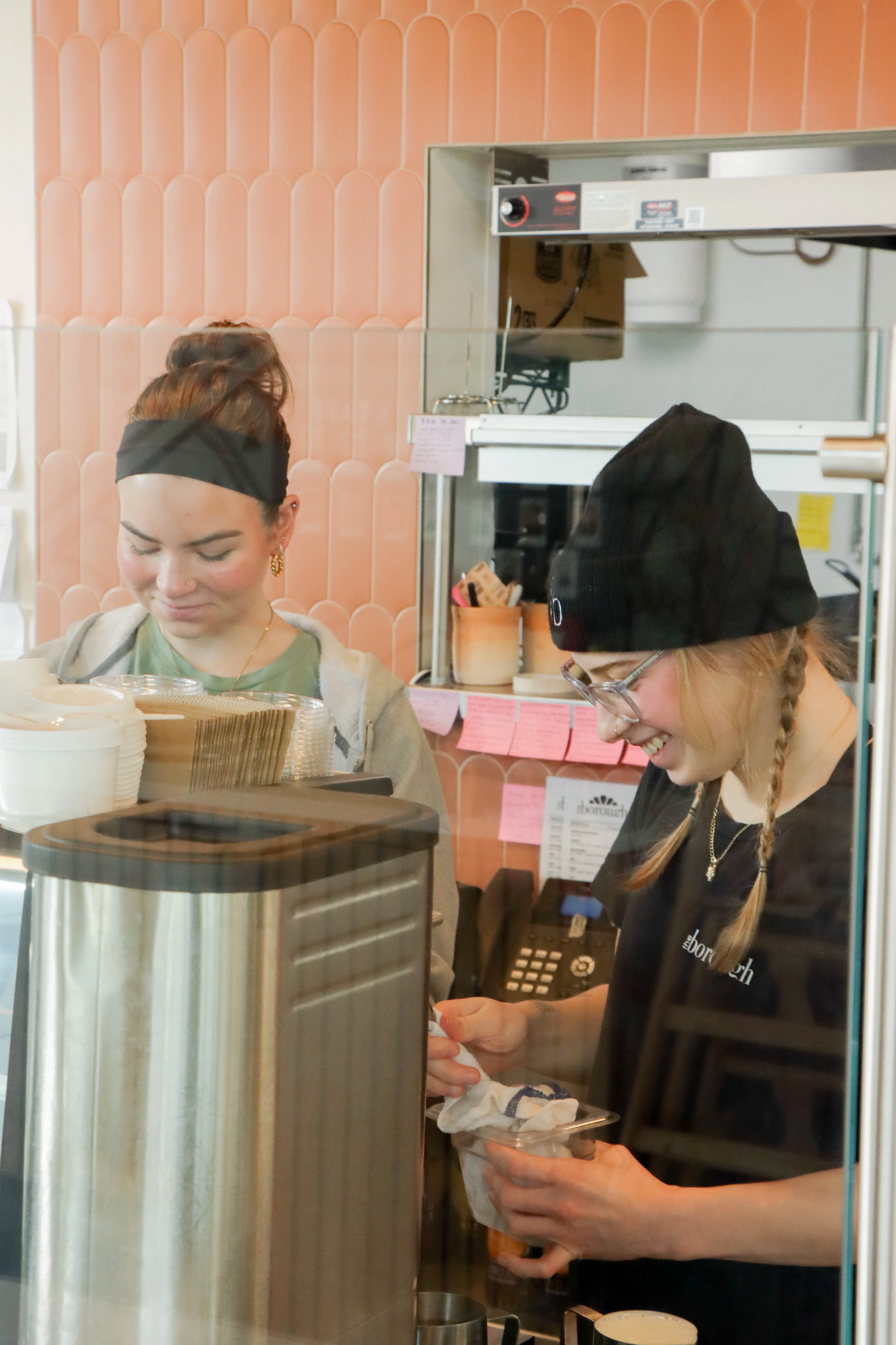 Two Girls Smiling while working in a cafe