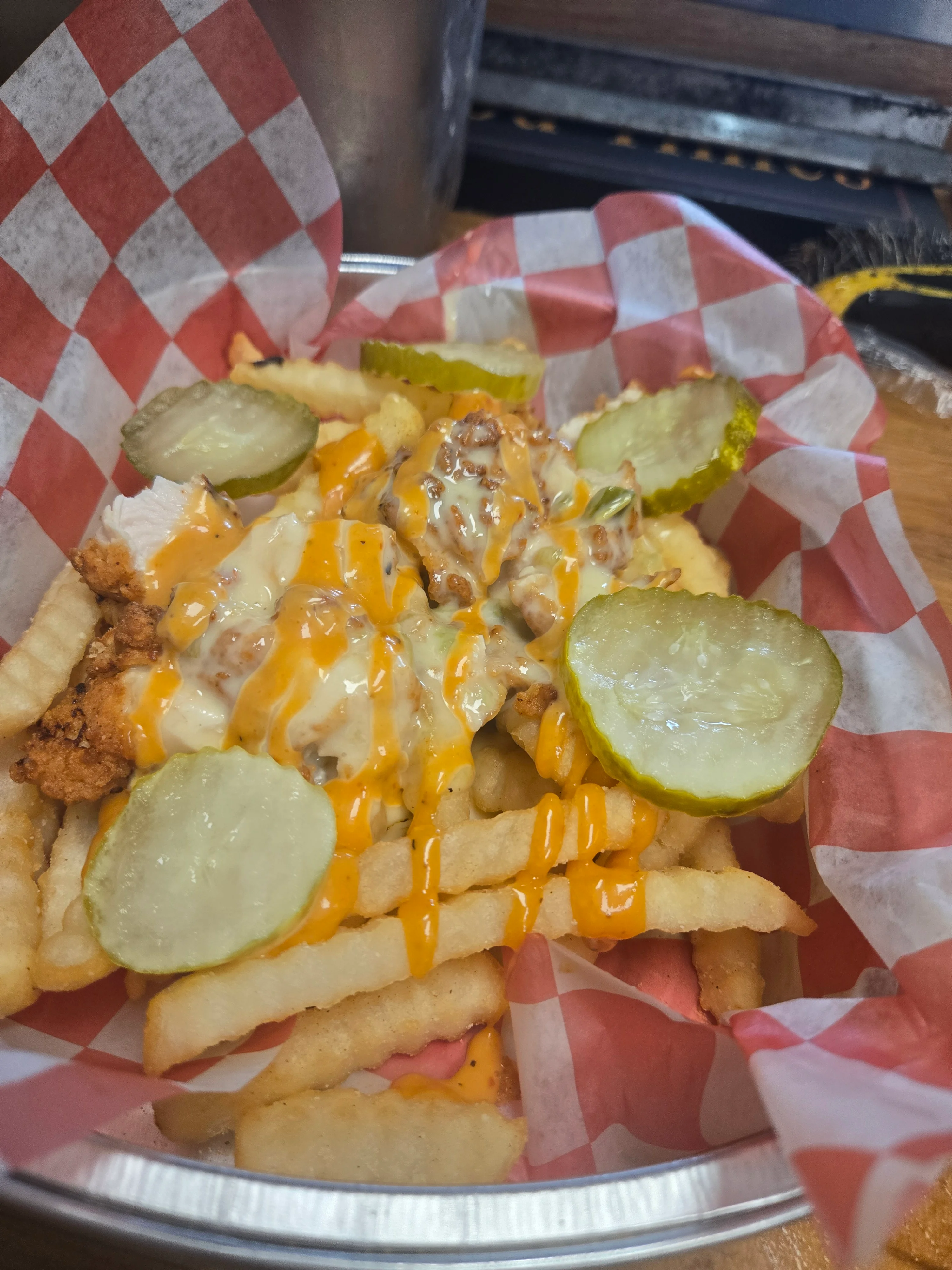 Loaded chicken fries with pickles and cheese sauce