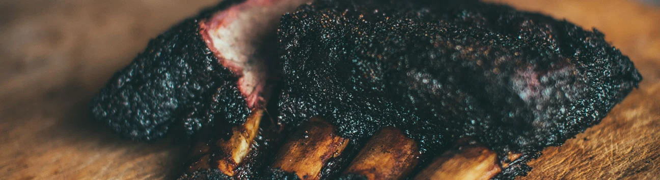 Smoked beef ribs with a rich, dark crust