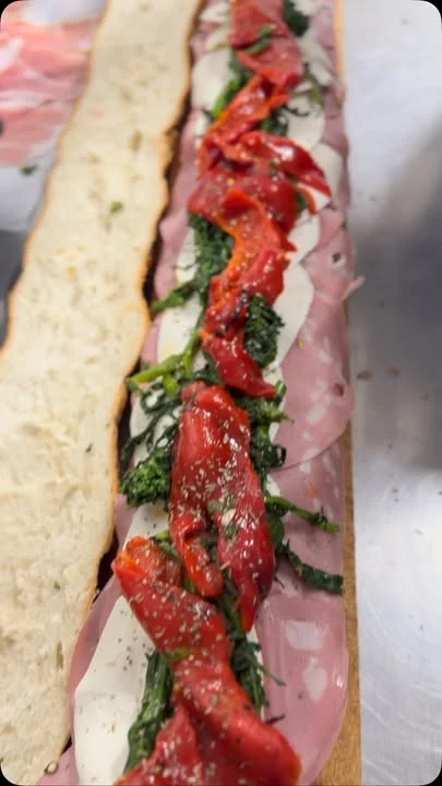 Italian sub sandwich with cured meats and roasted peppers