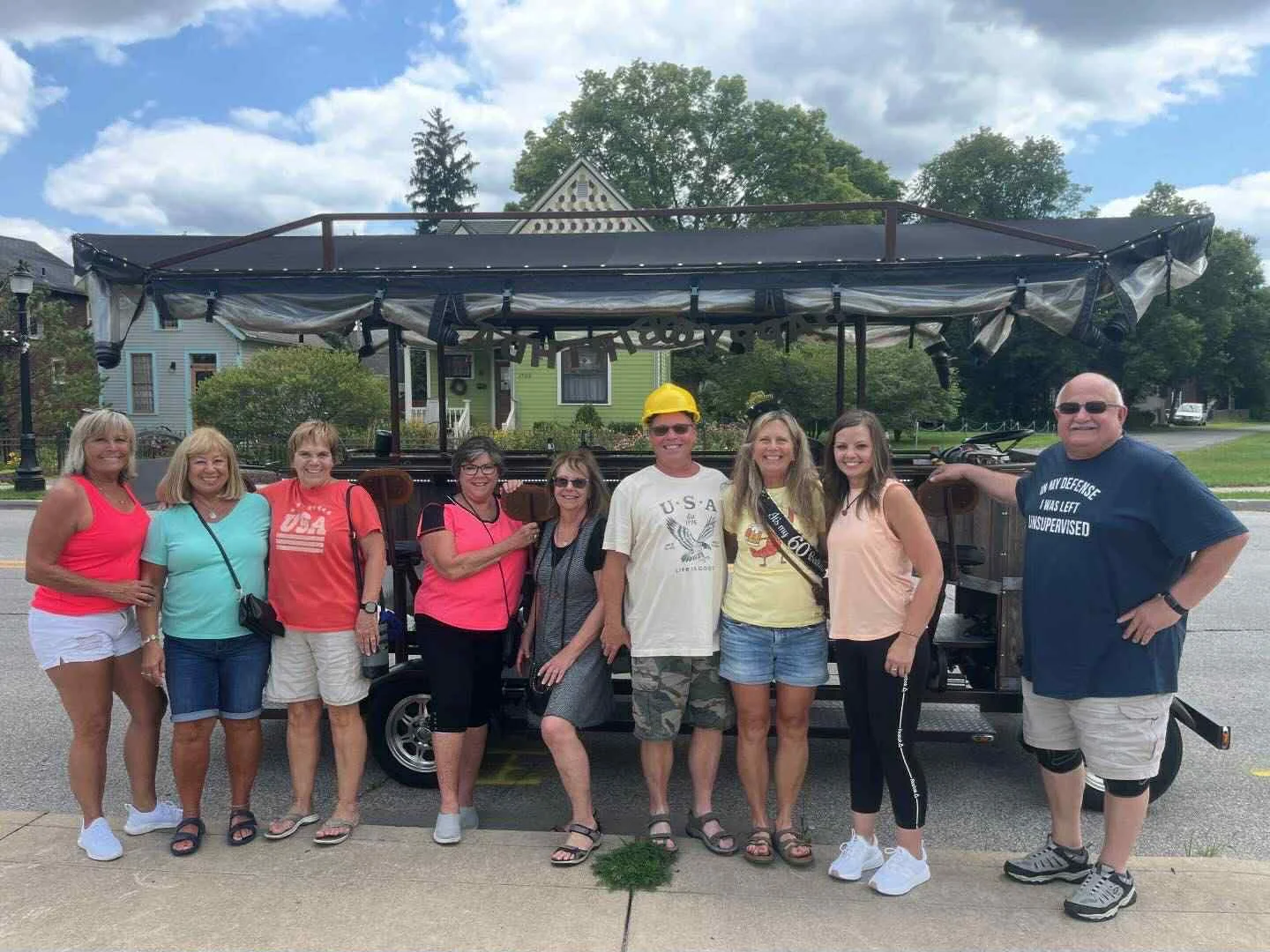 Group of friends enjoying a fun outing by a pedal-powered bar