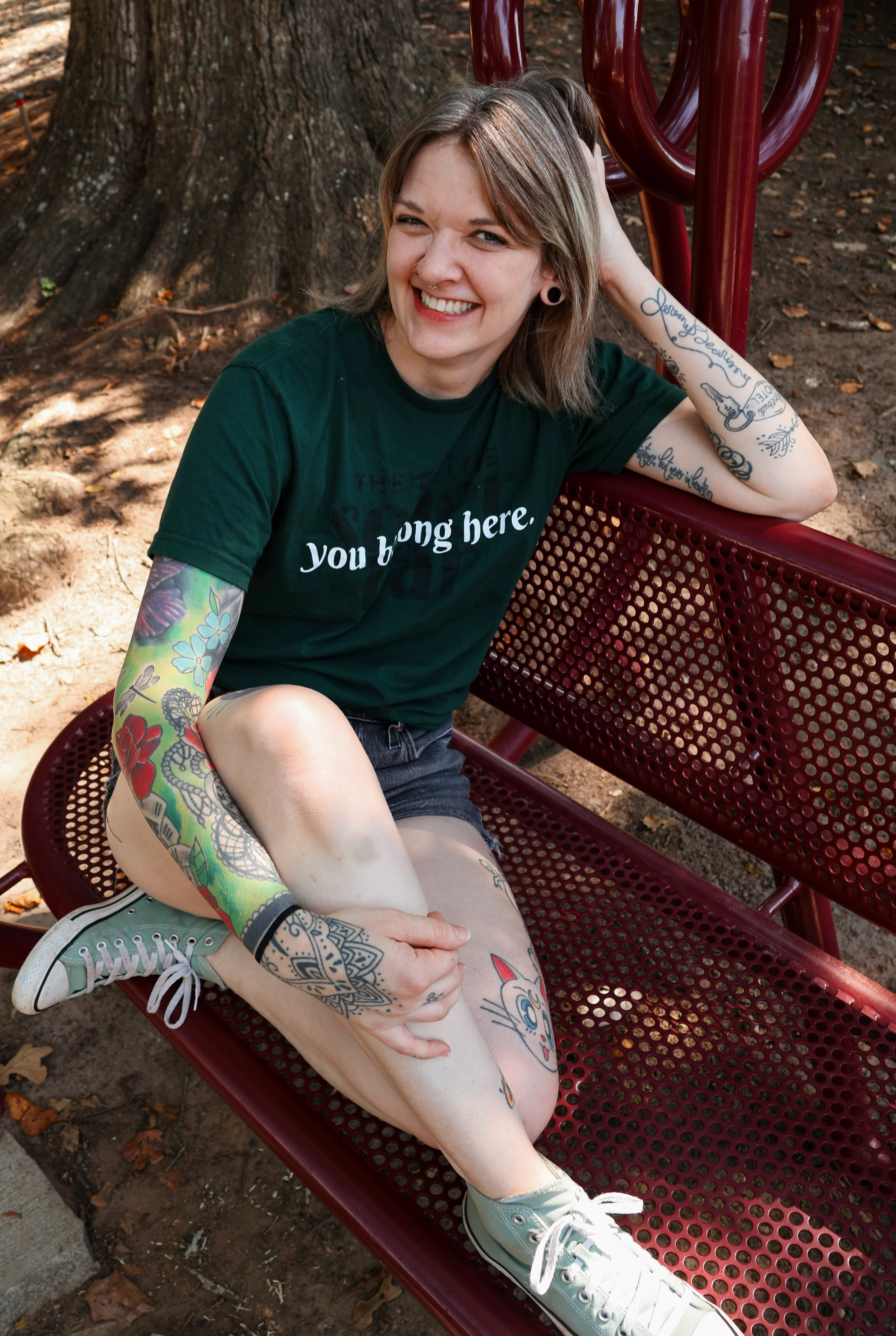 Smiling tattooed diner seated outdoors in a restaurant chair
