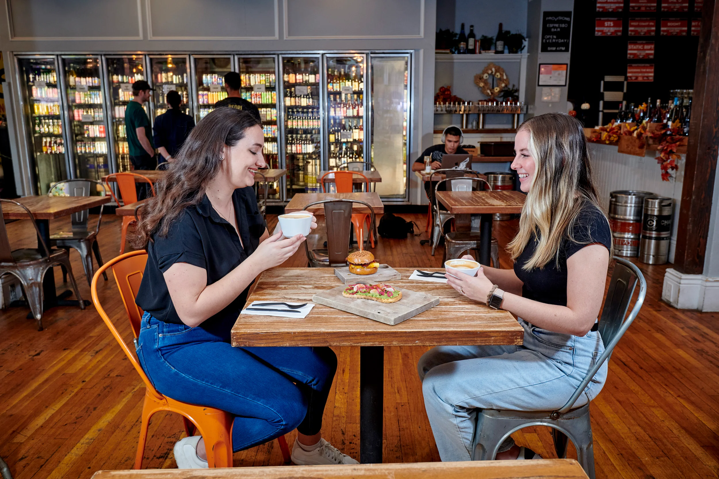 Cozy restaurant interior with friends enjoying coffee and snacks