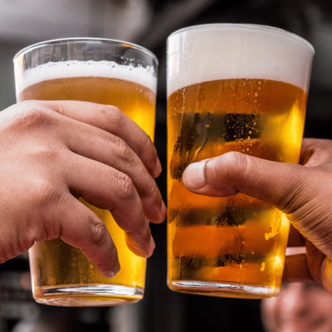 Cheers with two pints of golden lager beer