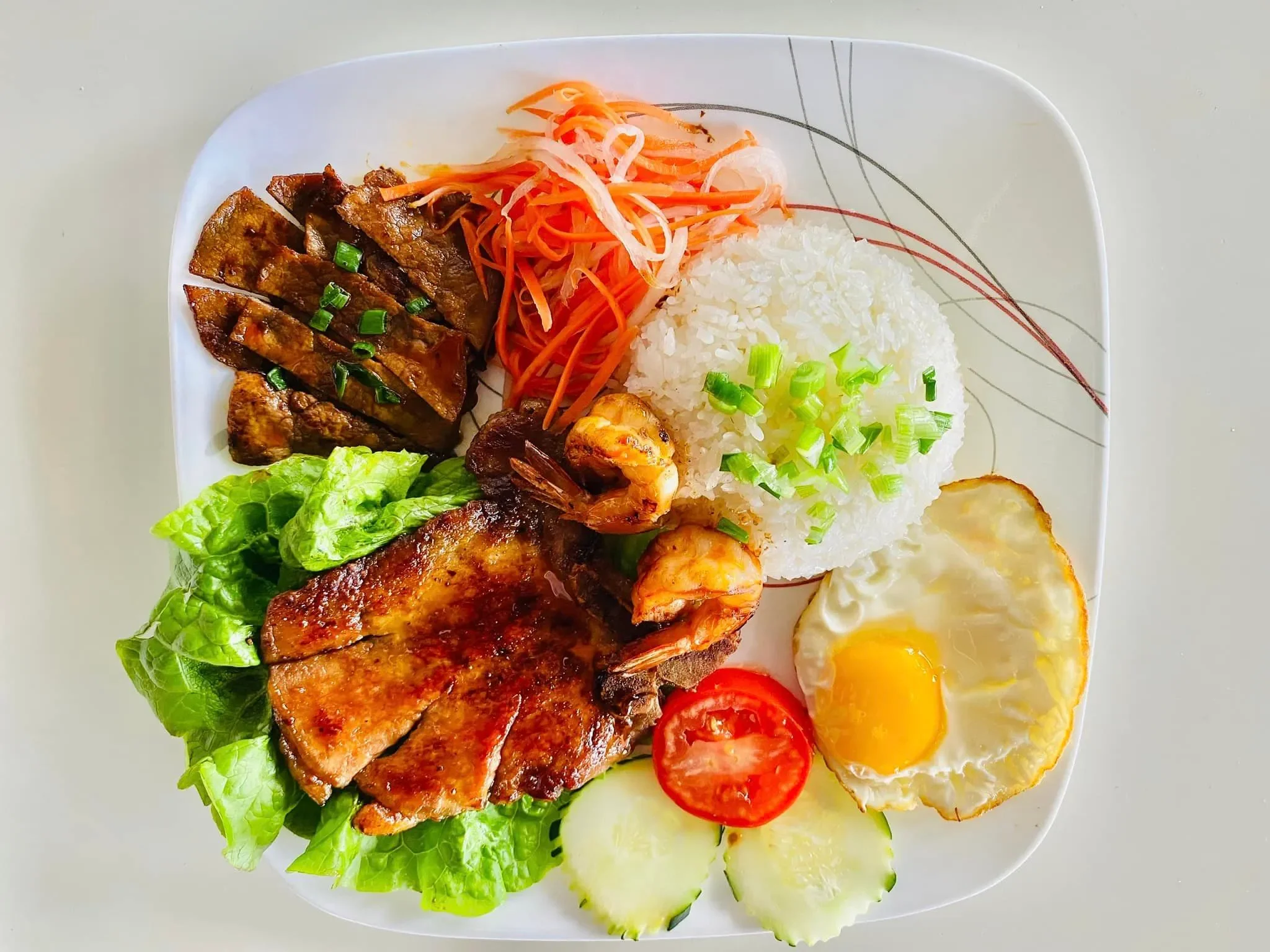 Vietnamese cơm tấm with grilled meats and fried egg