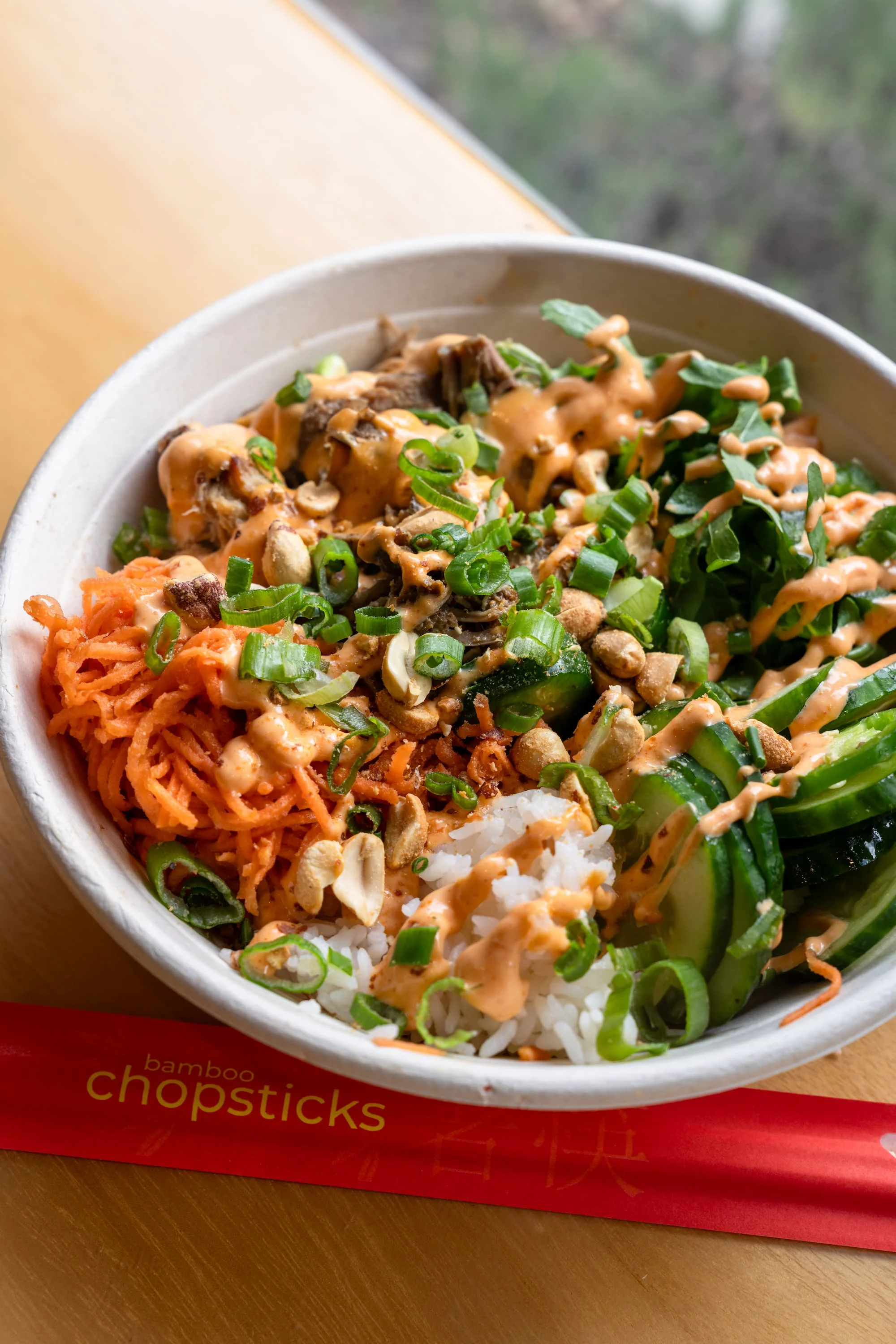 Bowl of Korean bibimbap with vegetables and spicy sauce