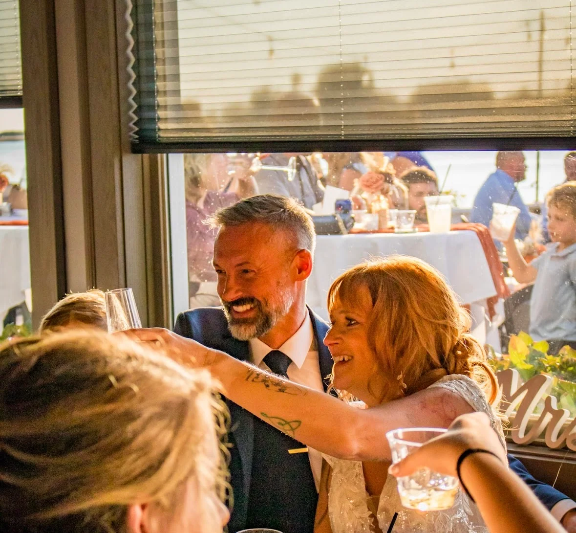 Couple celebrating with drinks at a wedding reception