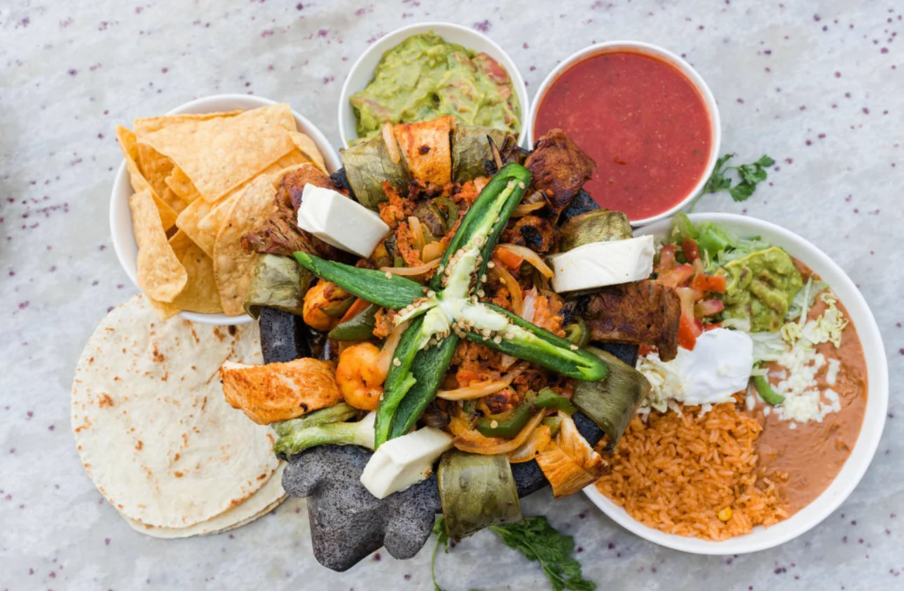 Sizzling Mexican fajitas served in a stone bowl